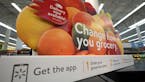 FILE- In this Nov. 9, 2018, file photo a sign promotes online and home delivery of groceries at a Walmart Supercenter in Houston. Grocery delivery ser