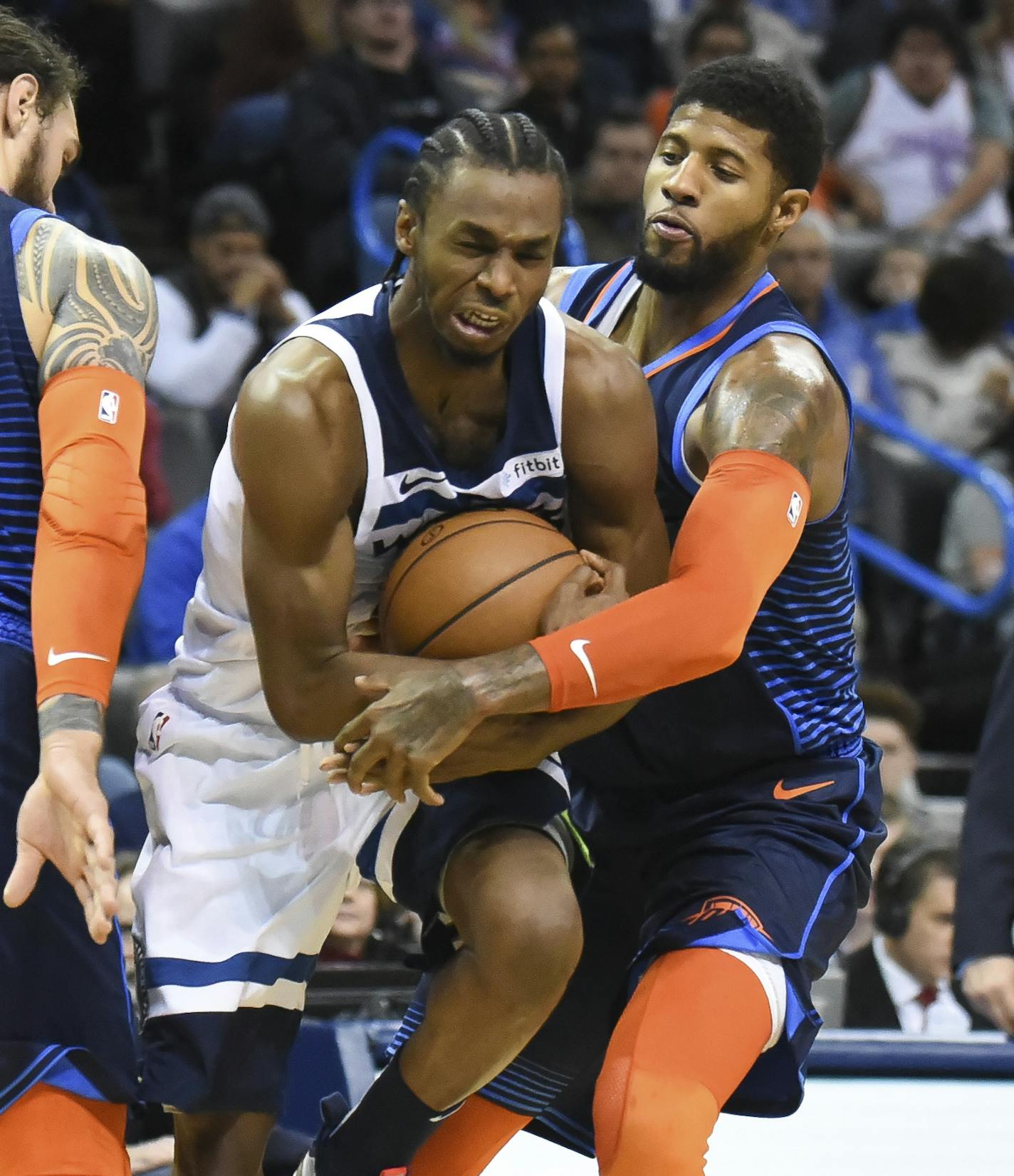 Oklahoma City Thunder forward Paul George, right, tries to get the ball away from Minnesota Timberwolves guard Andrew Wiggins, left, in the first half of an NBA basketball game in Oklahoma City, Sunday, Dec. 23, 2018. (AP Photo/Kyle Phillips)