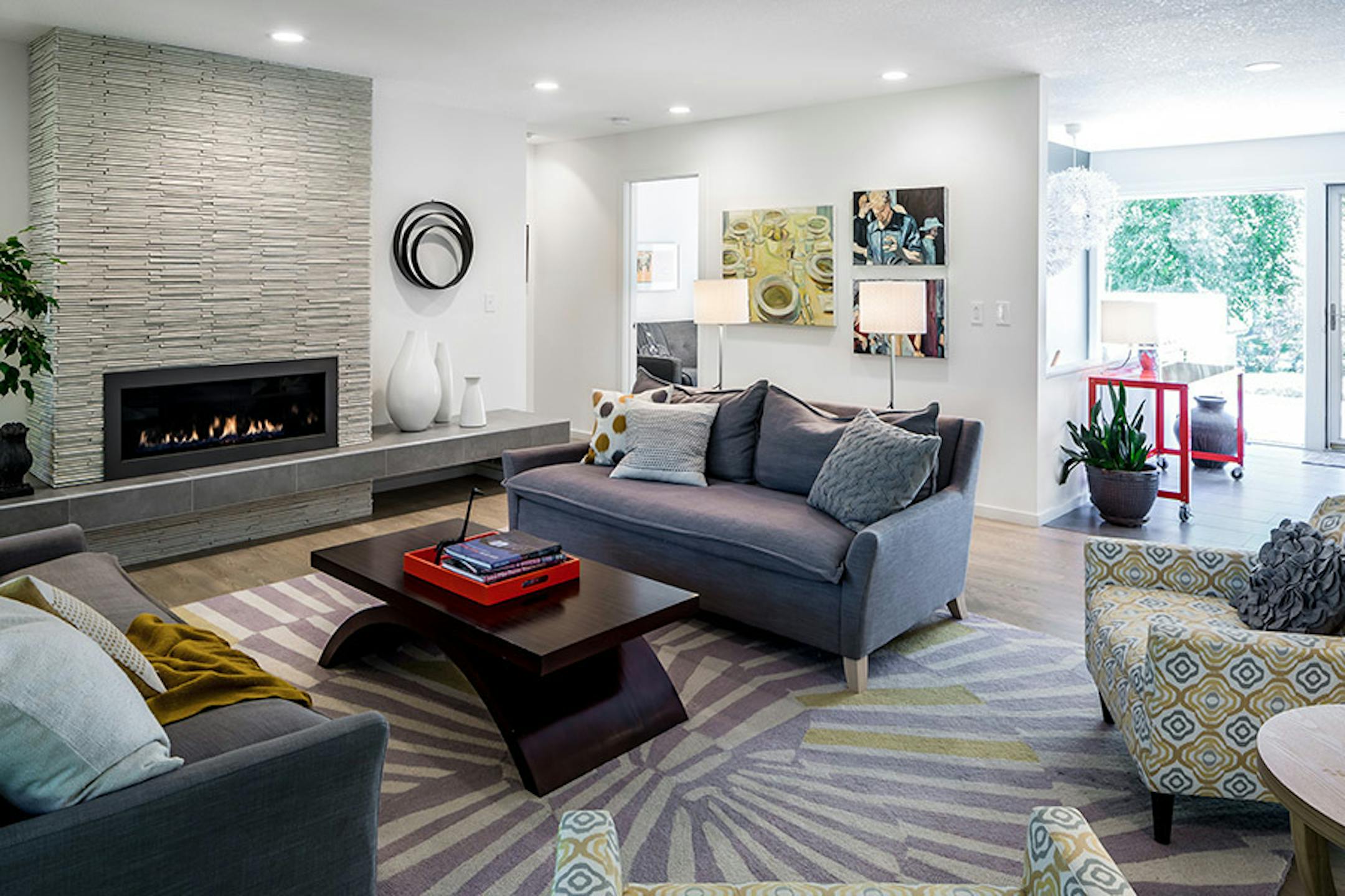 In the living room, a sleek linear gas fireplace fits the home's modern aesthetic. Shelter Architecture designed the renovation of 1970s North Oaks house.