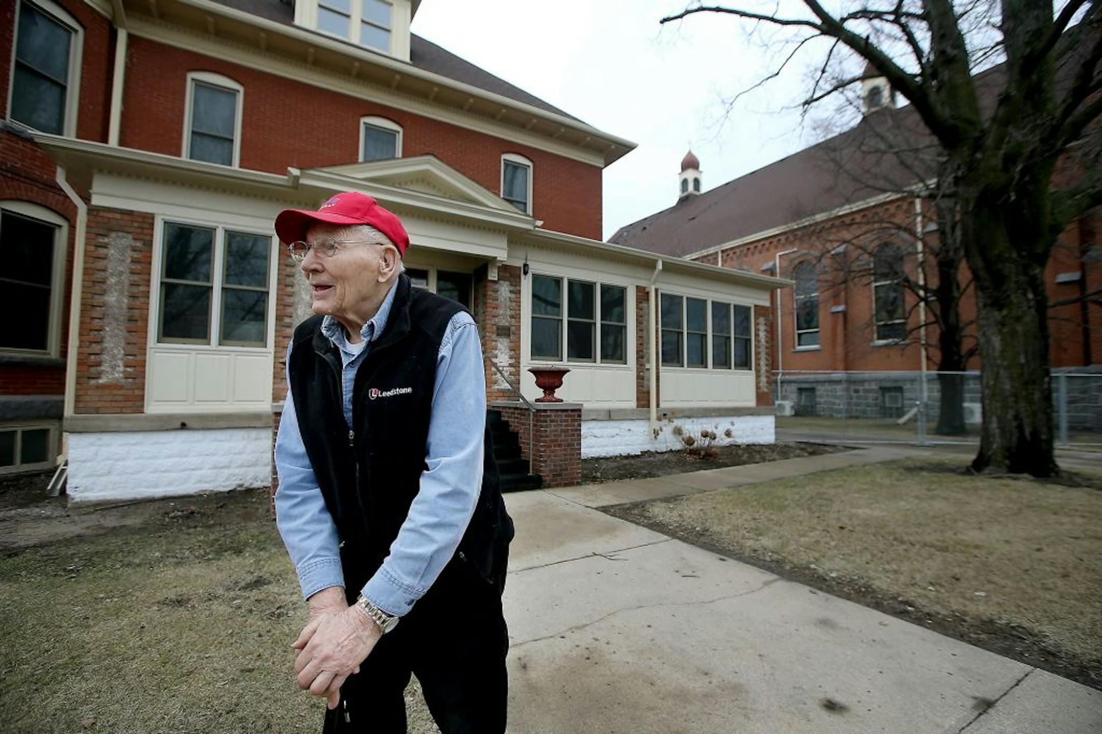 Mel Roehrl, 90, stood outside the historic St. Mary's Catholic Church as he talked to the church janitor Allan Wichmann, cq, Monday, March 14, 2016 in Melrose, MN. Federal agents arrived on Monday to investigate the fire that damaged about 30 percent of the 120-year-old church.