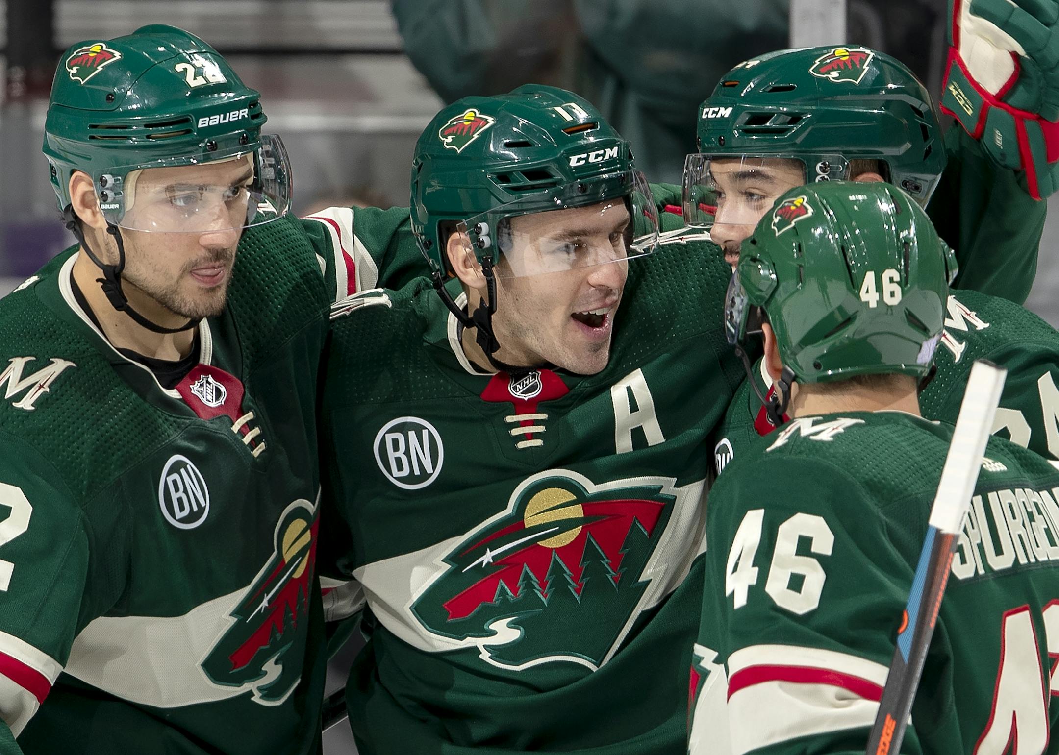Zach Parise (11) celebrated with teammates after scoring a goal in the second period.