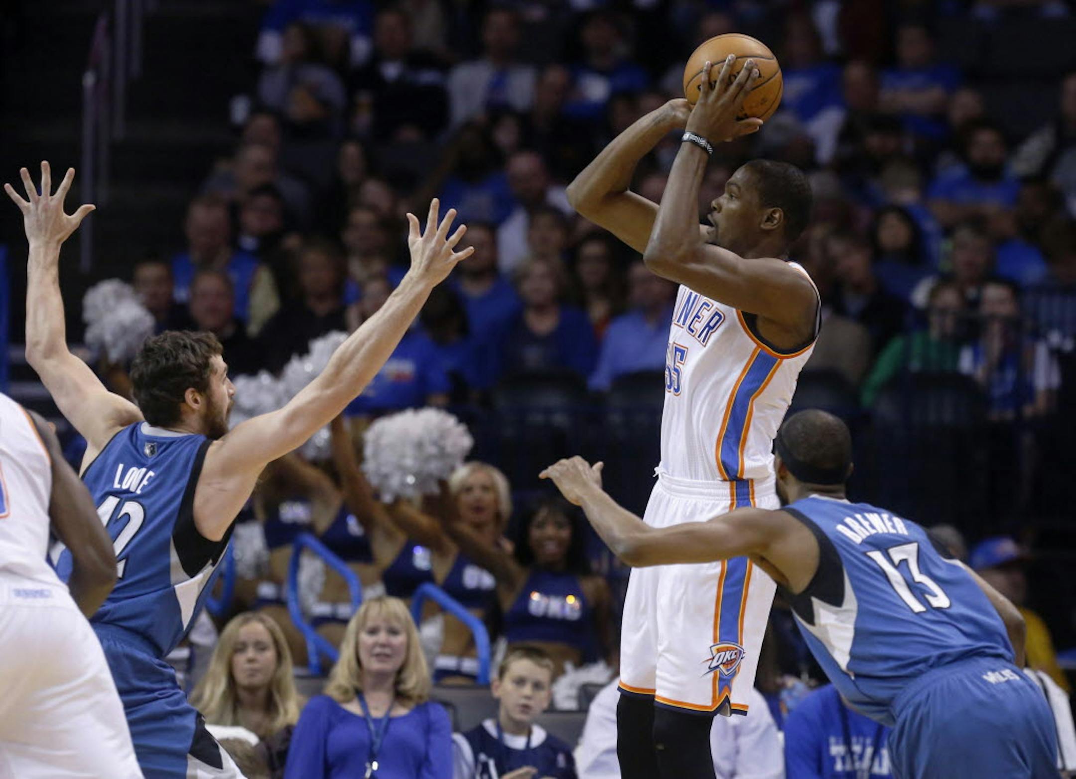Oklahoma City's Kevin Durant (35) shoots over Minnesota's Kevin Love (42) and Alexey Shved (13).