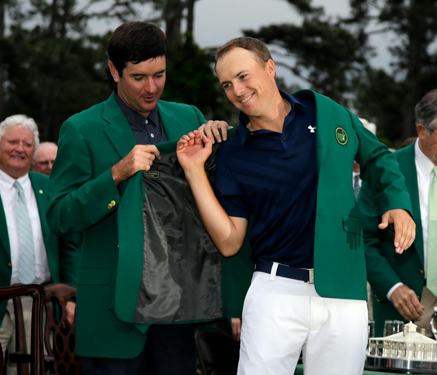 Bubba Watson helps Jordan Spieth put on his green jacket after winning the Masters golf tournament Sunday, April 12, 2015, in Augusta, Ga. (AP Photo/Matt Slocum)