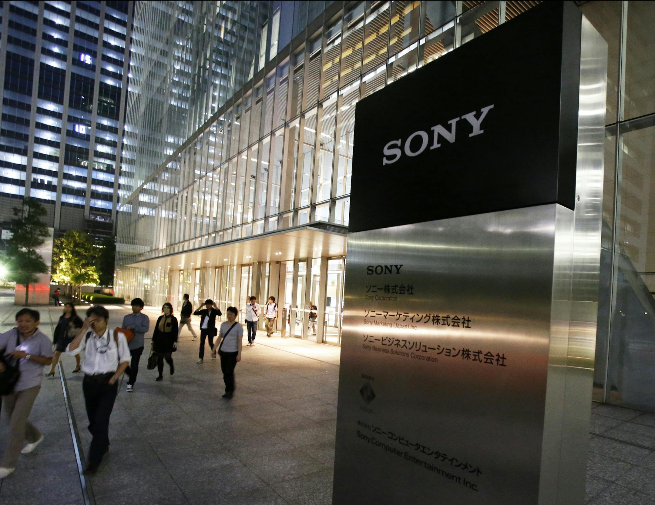 Employees leave the headquarters of Sony Corp. in Tokyo Wednesday, Sept. 17, 2014. Sony expects its annual loss to swell to $2 billion and has canceled dividends for the first time in more than half a century after writing down the value of its troubled smartphone business. Citing intense competition, especially from Chinese rivals, Sony said Wednesday it anticipates a net loss of 230 billion yen ($2.15 billion) for the fiscal year that ends March 31, 2015. (AP Photo/Toru Takahashi)