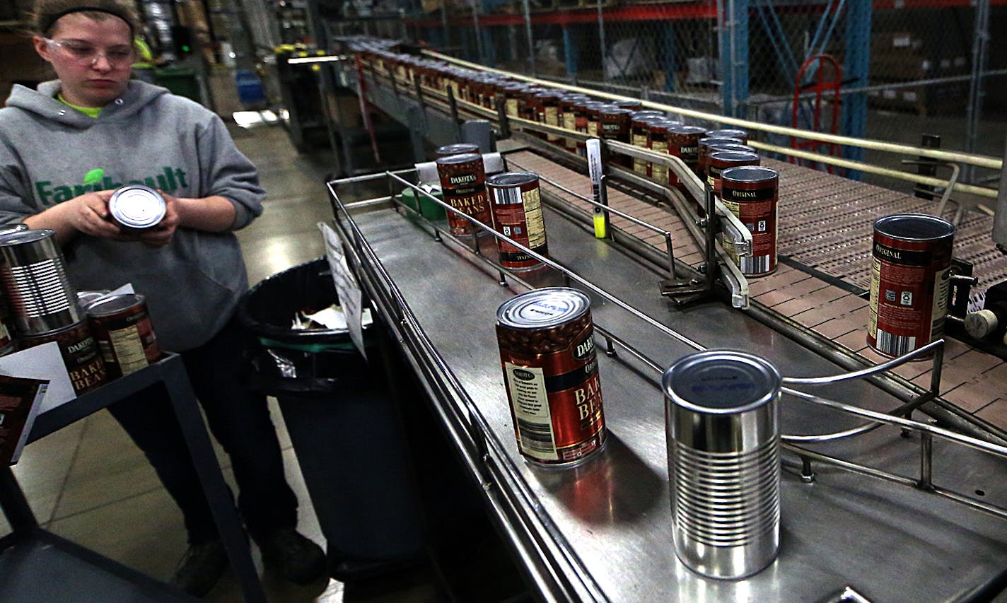 Some cans are pulled from the production line at a quality control station.