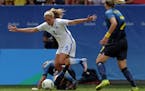 United States' Allie Long and Sweden's Kosovare Asllani, on the ground, fight for the ball during a quarter-finals match of the women's Olympic footba