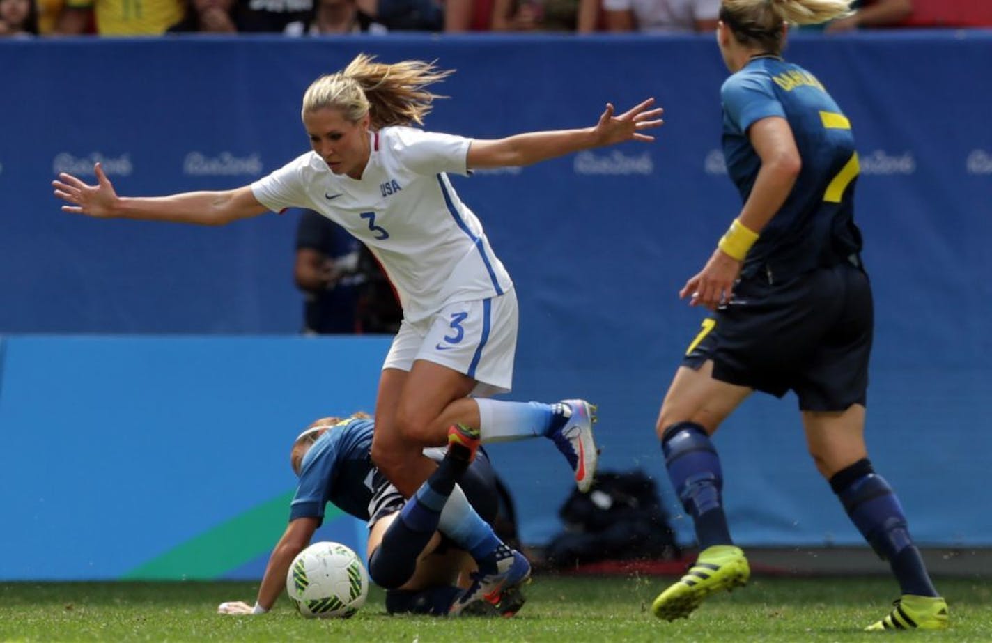 United States' Allie Long and Sweden's Kosovare Asllani, on the ground, fight for the ball during a quarter-finals match of the women's Olympic football tournament between the United States and Sweden in Brasilia Friday Aug. 12, 2016.