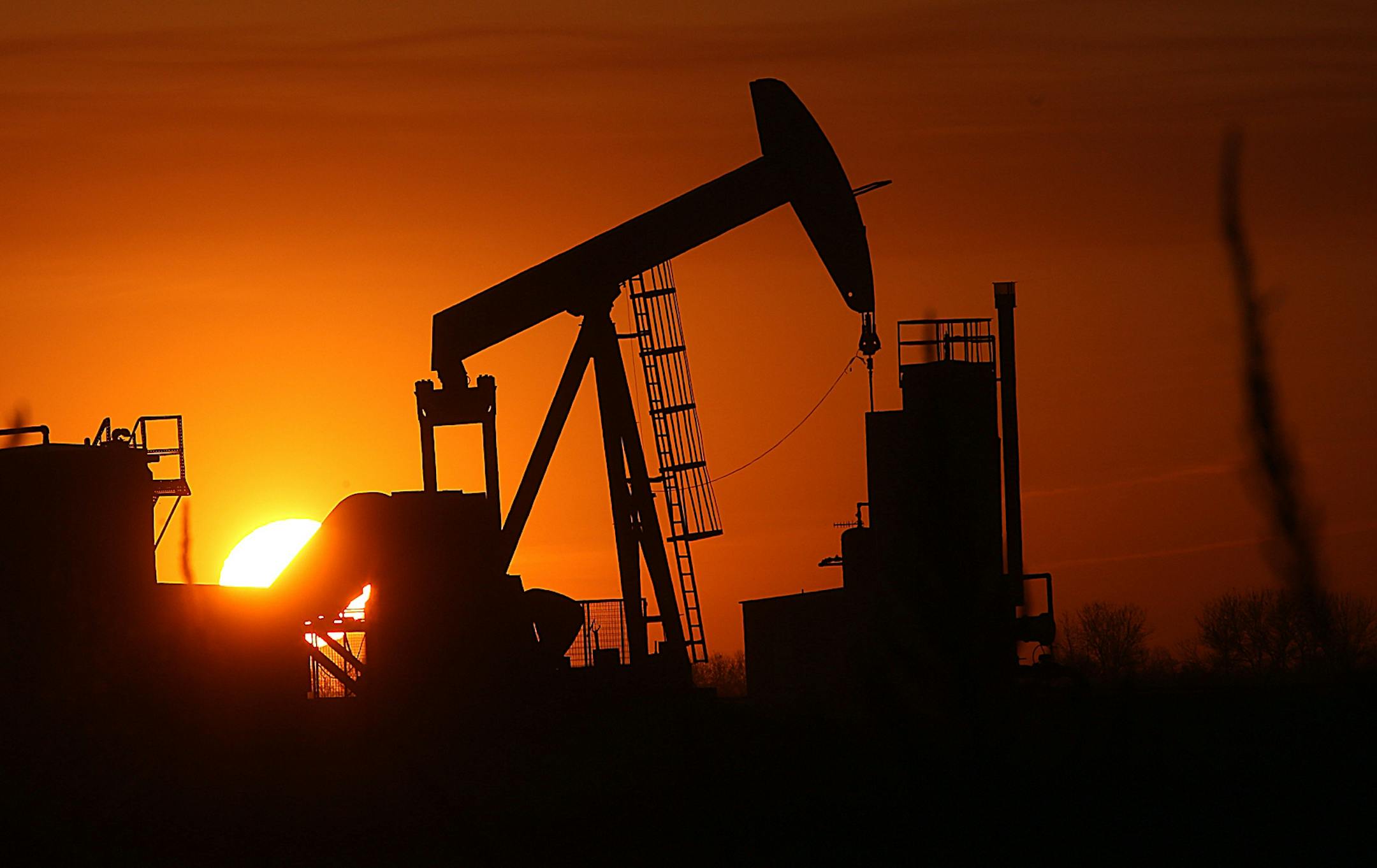 The sun set over the Bakken Oil Formation, behind an oil well near Williston, N.D.