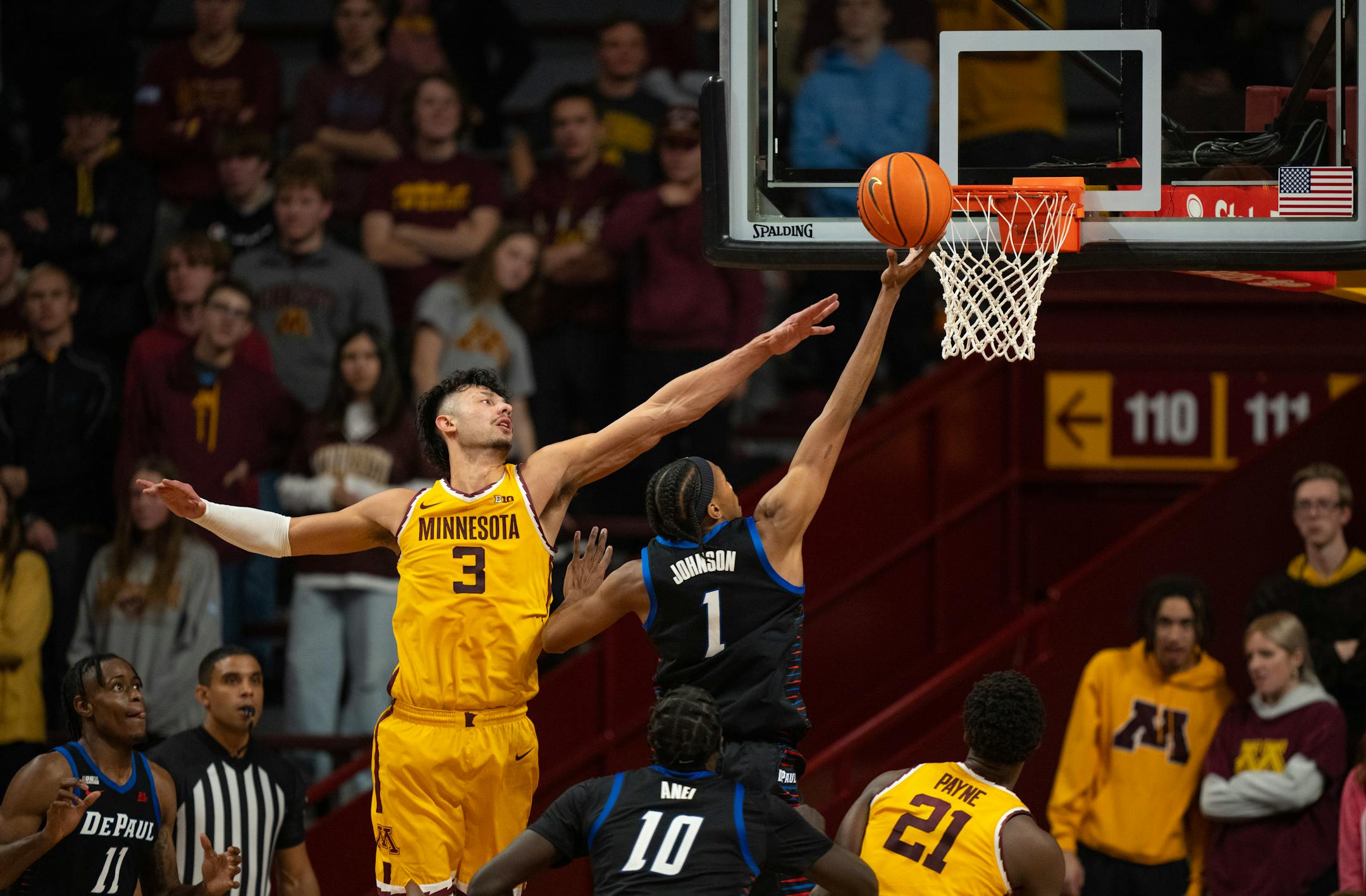 Minnesota Gophers forward Dawson Garcia (3) tried to defend DePaul Blue Demons forward Javan Johnson (1) in the second half.