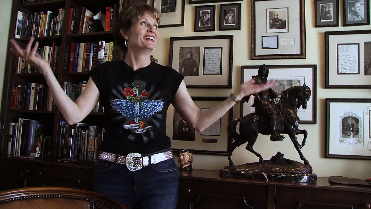 KARE11 anchor Diana Pierce points out the treasured books and collectibles in the library that also serves as the piano room.