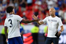 Coach Gregg Berhalter of the United States, right, greets his player Chris Richards after losing 0-1 against Uruguay at the end of a Copa America Grou