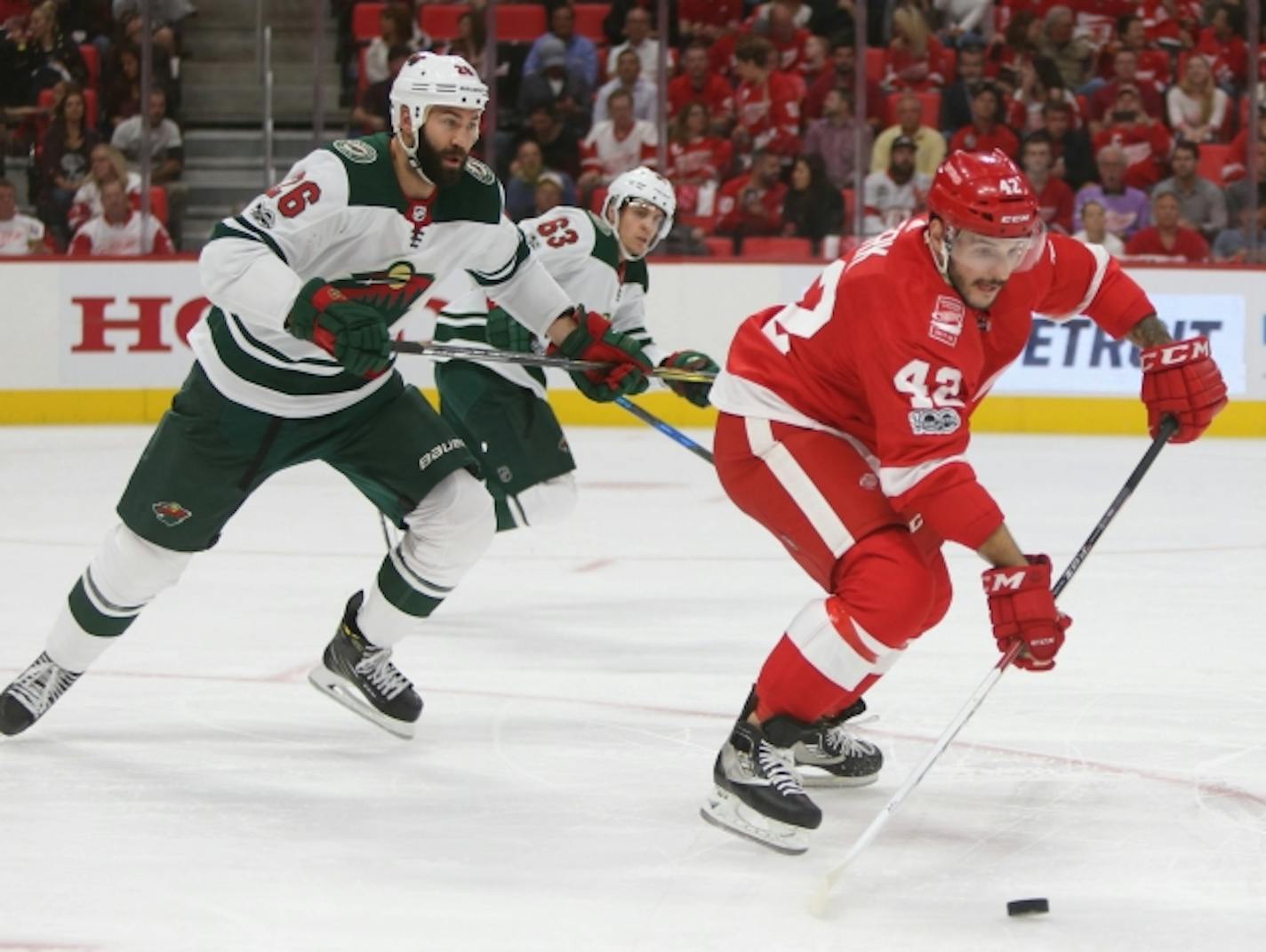 The Detroit Red Wings' Martin Frk (42) is defended by the Minnesota Wild's Daniel Winnik during first-period action at Little Caesars Arena in Detroit on Thursday, Oct. 5, 2017. (Kirthmon F. Dozier/Detroit Free Press/TNS) ORG XMIT: 1212705