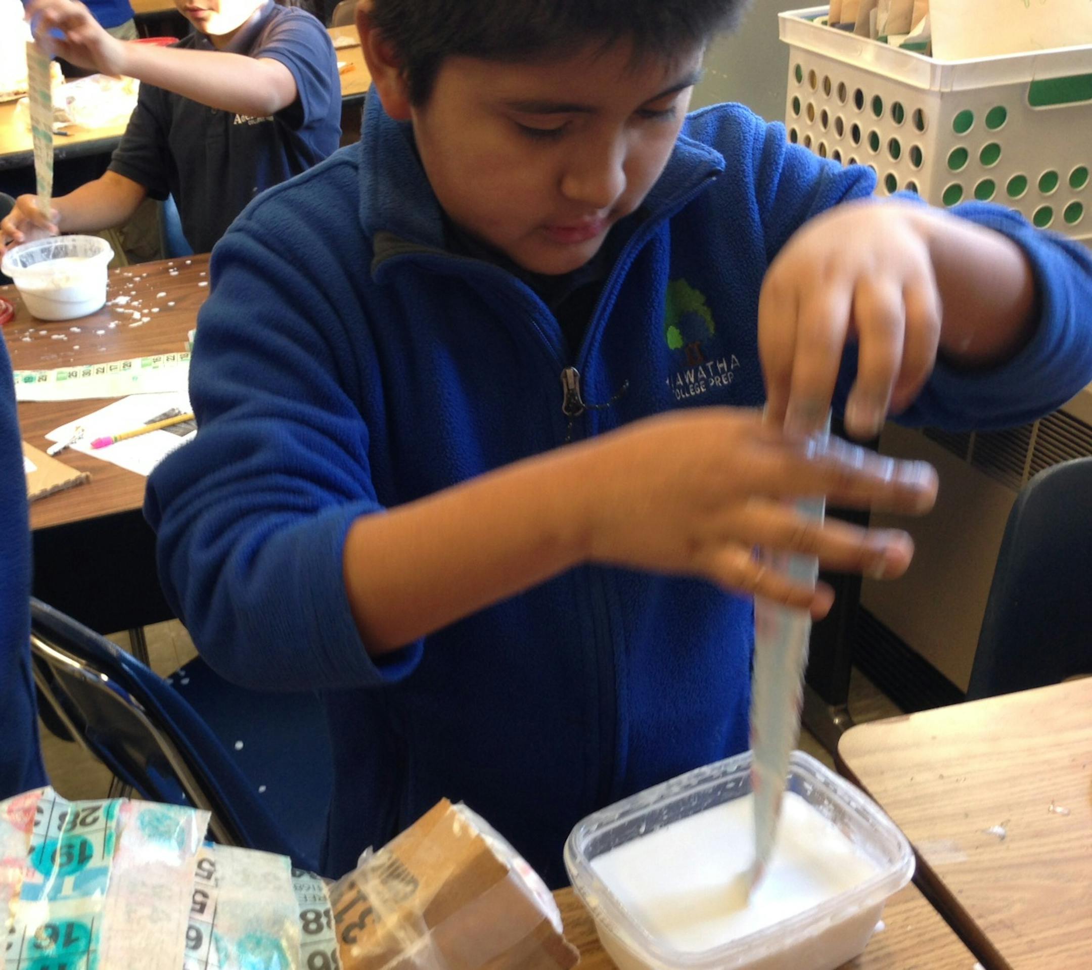 Xavier Ysguaillas, a sixth grader at Hiawatha College Prep in Minneapolis, woks on a paper mache figure for an art project. He is one of a group of middle school students that the parent charter school organization hopes to house temporarily in a new building when they reach high school.