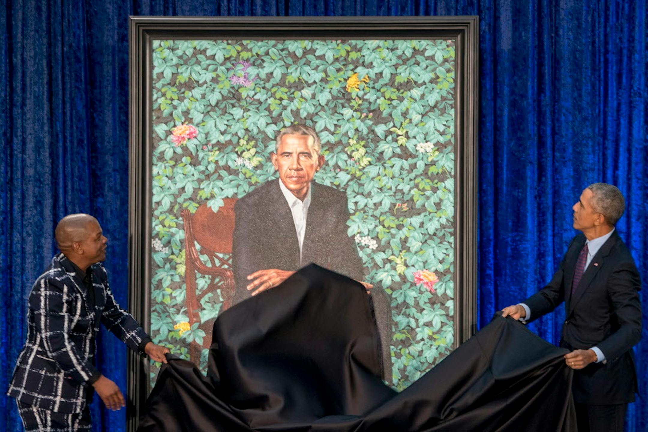Former President Barack Obama, right, and Artist Kehinde Wiley, left, unveil Obama's official portrait at the Smithsonian's National Portrait Gallery, Monday, Feb. 12, 2018, in Washington. (AP Photo/Andrew Harnik)