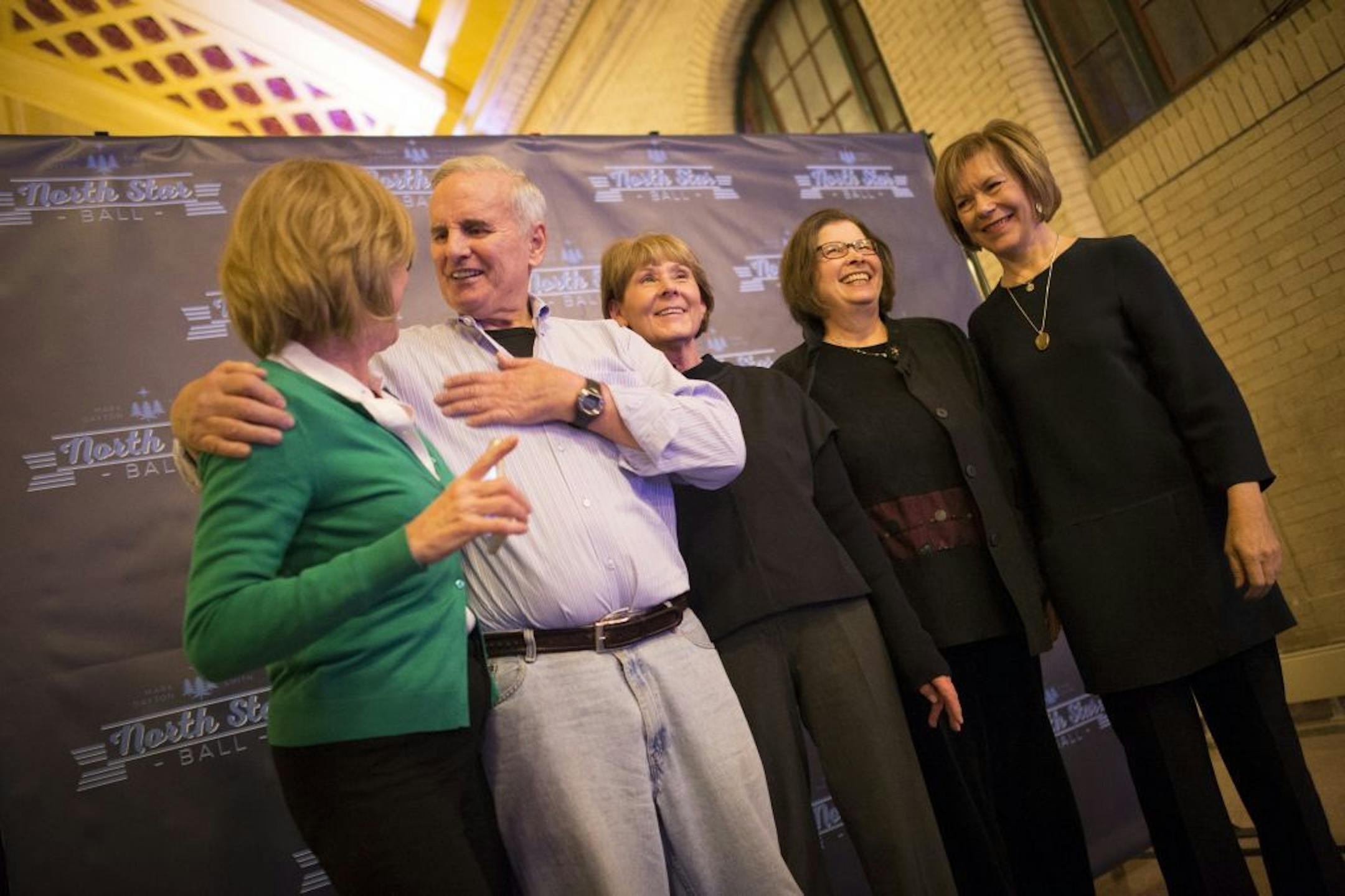 From left, Judie Fos speaks to Gov. Mark Dayton as Suzanne Edwards, Mary Gross and Lt. Gov. Tina Smith prepare to have their photo taken on Saturday night.