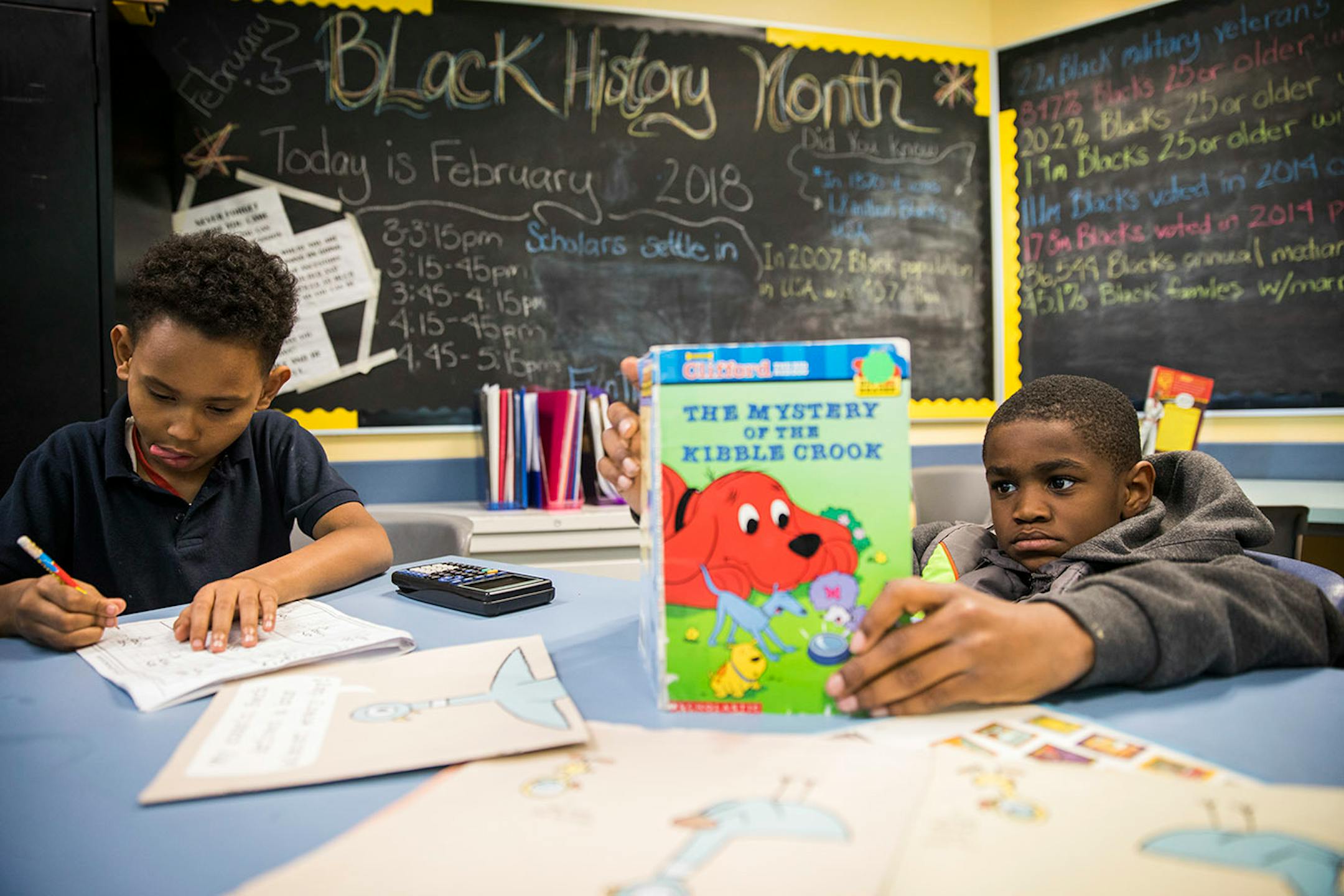 Shahid Smith, left, 9, works on math problems as Jackson Yancy, 10, gets some reading done.