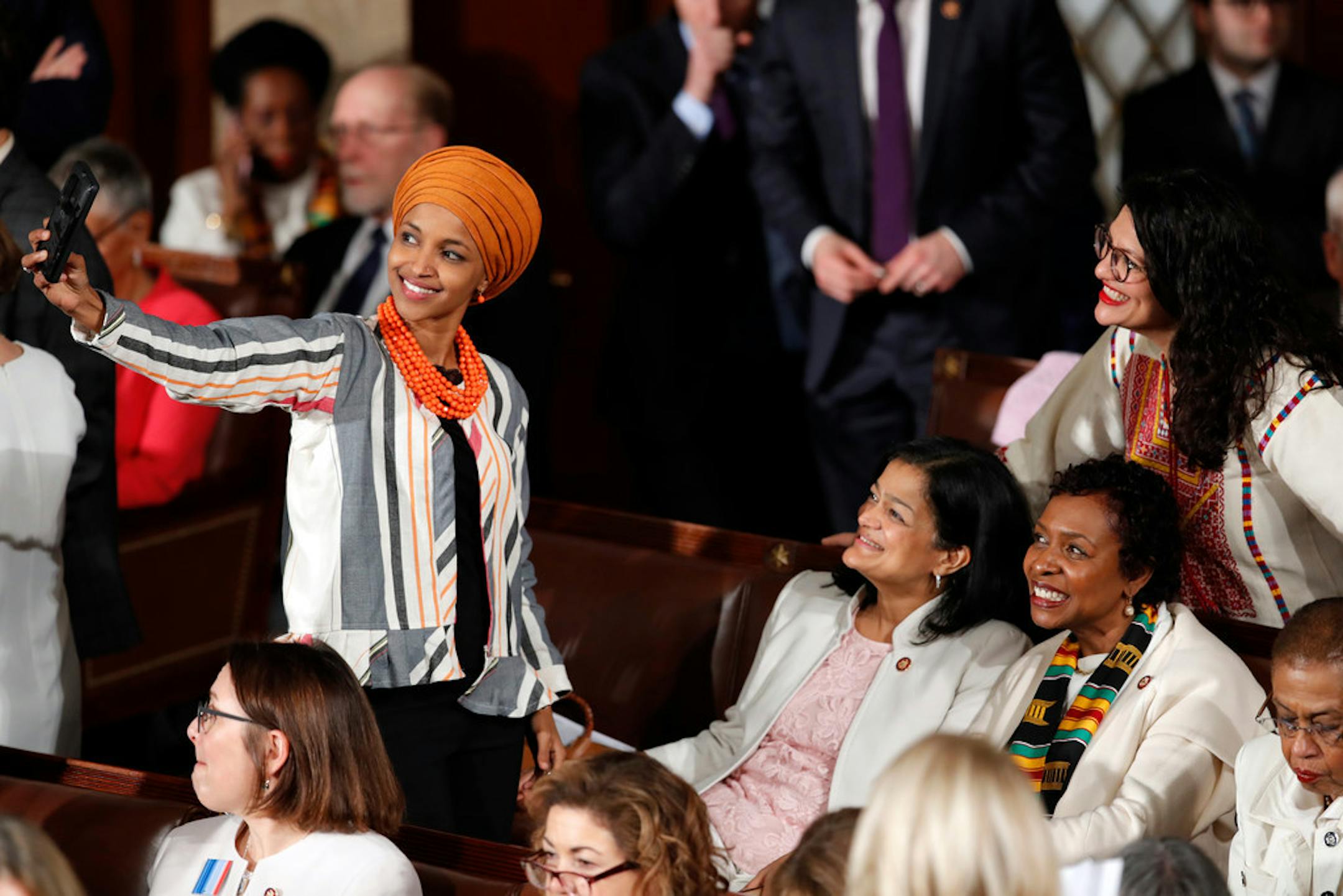Rep. Ilhan Omar, D-Minn., left, and takes a selfie with Rep. Rashida Tlaib., D-Mich., standing right, along with Rep. Pramila Jayapal, center, arrive before President Donald Trump delivers his State of the Union address on Tuesday.