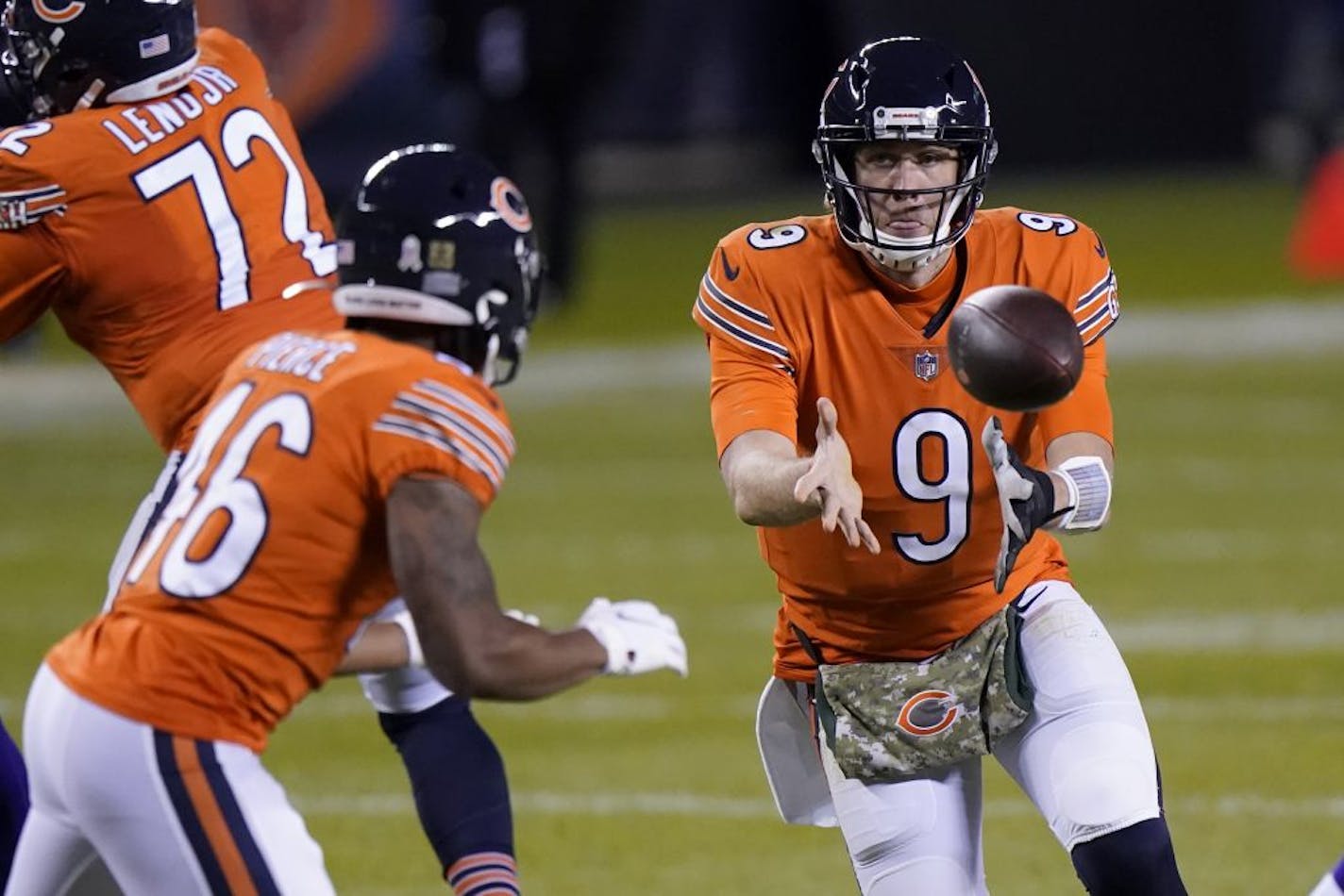 Chicago Bears quarterback Nick Foles (9) laterals to running back Artavis Pierce (46) during the second half of an NFL football game against the Minnesota Vikings Monday, Nov. 16, 2020, in Chicago.