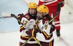 Gophers forward Grace Zumwinkle (12) was mobbed by Taylor Heise during a game earlier this season.