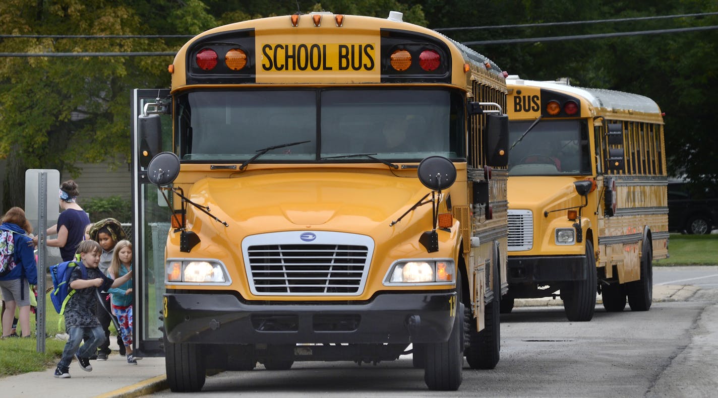 Students board buses at Frances Slocum Elementary School in Marion, Ind., after classes on Thursday, Aug. 16, 2018. Marion Community Schools is looking for more bus drivers. (Jeff Morehead/The Chronicle-Tribune via AP)