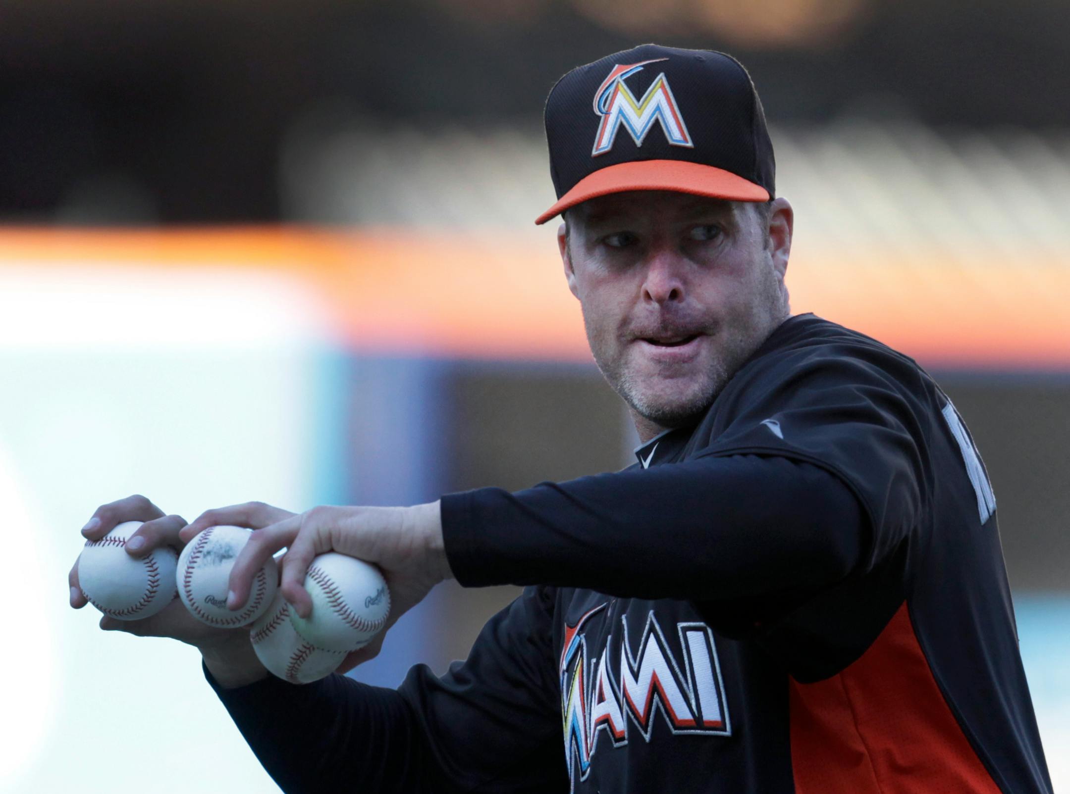 Miami Marlins manager Mike Redmond throws batting practice prior to a baseball game against the New York Mets at Citi Field, Friday, April 5, 2013 in New York. (AP Photo/Mark Lennihan)