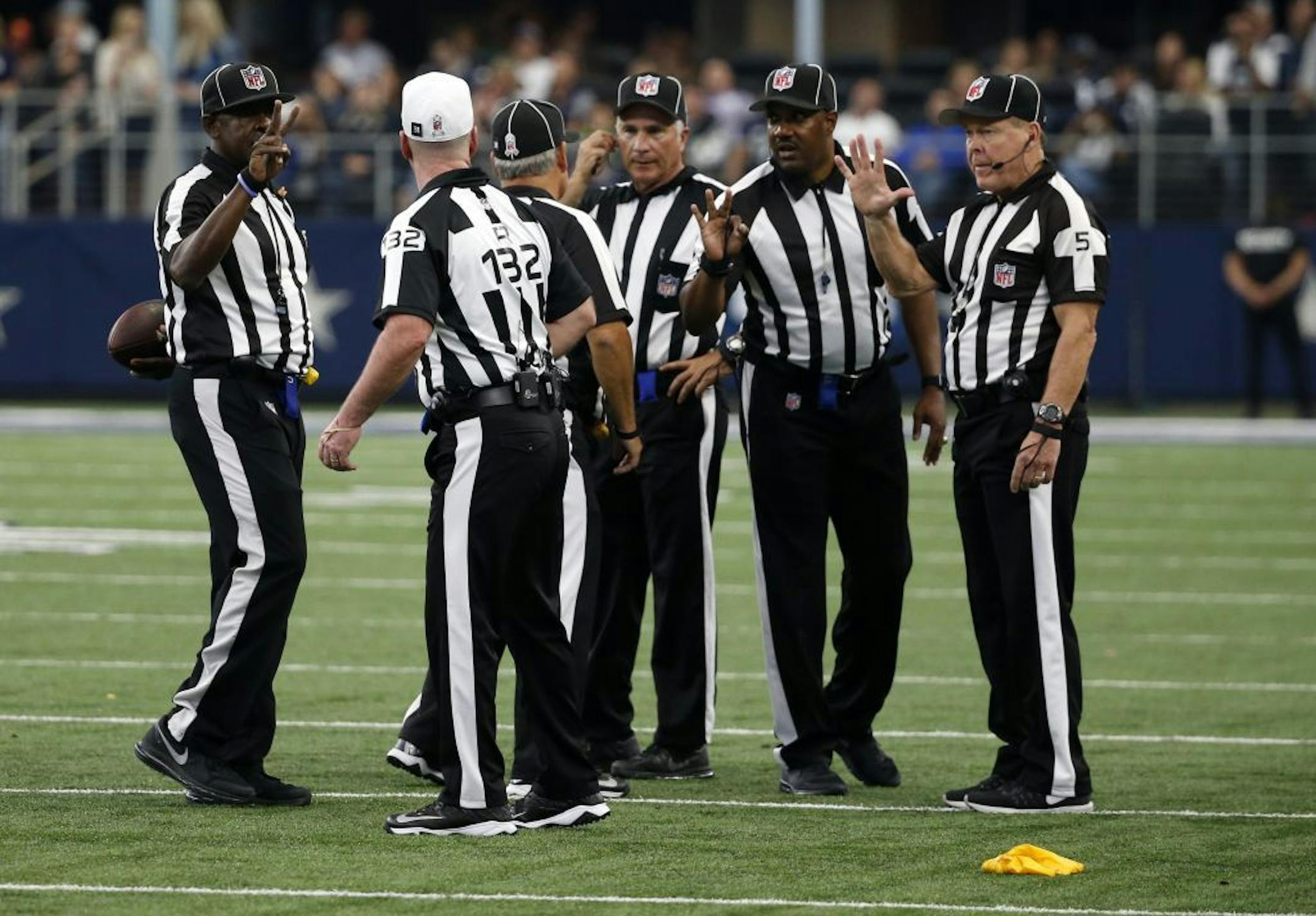 Referee John Parry (132) conferred with the officiating crew after a penalty during a game between the Baltimore Ravens and Dallas Cowboys on Nov. 20.