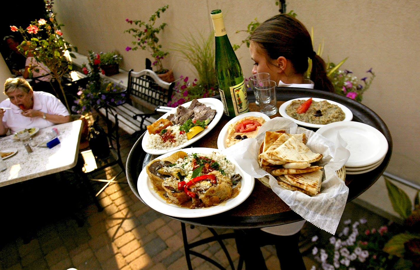 It's Greek To Me, serves up authentic Greek food and has a large outdoor seating area attached to the restaurant. Ena Englund hoists a tray of hearty, moderately-priced fare.