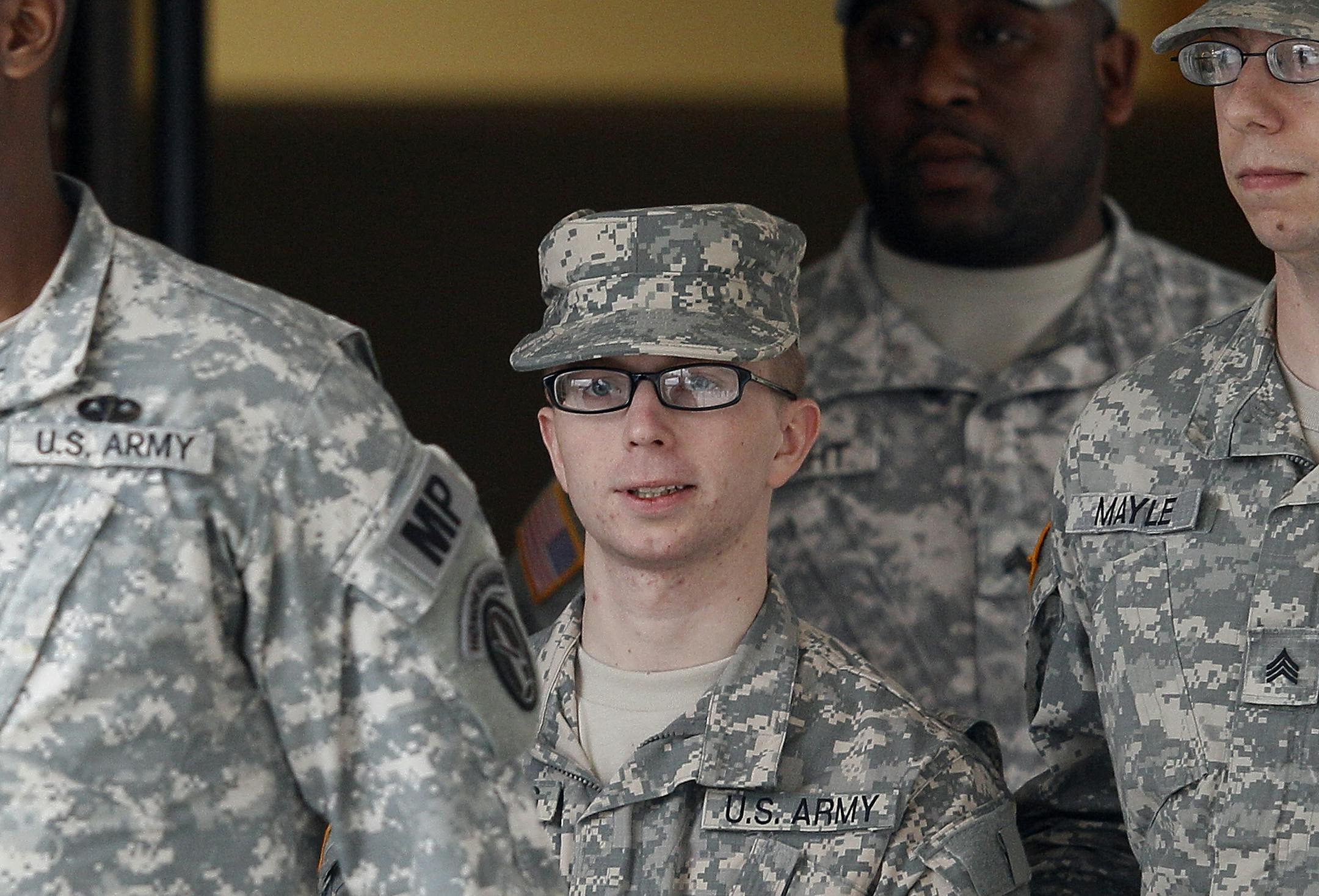 Dec. 2011: Army Pfc. Bradley Manning, center, is escorted out of a courthouse in Fort Meade, Md.