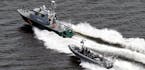 Boats of the Finnish Border Guard patrol the waters outside Helsinki Tuesday, April 28, 2015. The Finnish military said it has dropped depth charges o