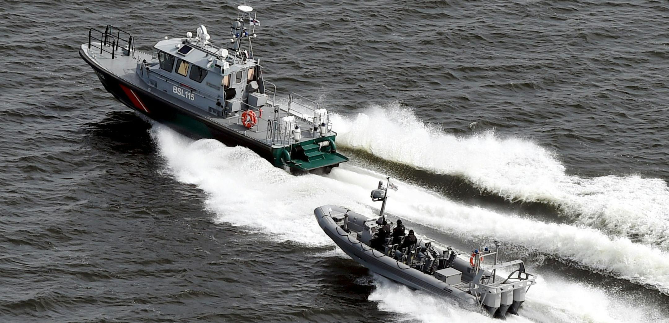 Boats of the Finnish Border Guard patrol the waters outside Helsinki Tuesday, April 28, 2015. The Finnish military said it has dropped depth charges onto a suspected submarine in the sea outside Helsinki after twice detecting the presence of a foreign object in the area. (Jussi Nukari/LEHTIKUVA via AP) FINLAND OUT ORG XMIT: LON807