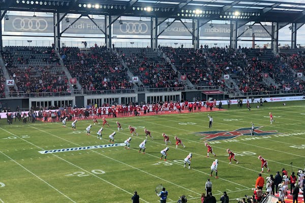 The D.C. Defenders, right, lined up against the Seattle Dragons for the opening kickoff of the opening football game of the XFL season