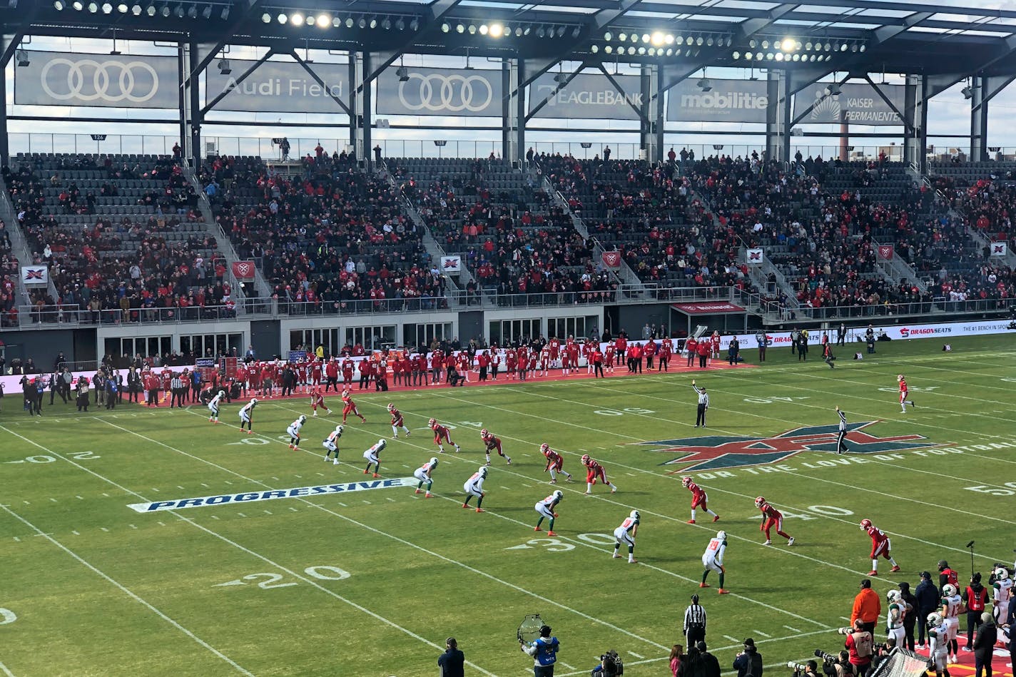 The D.C. Defenders, right, lined up against the Seattle Dragons for the opening kickoff of the opening football game of the XFL season