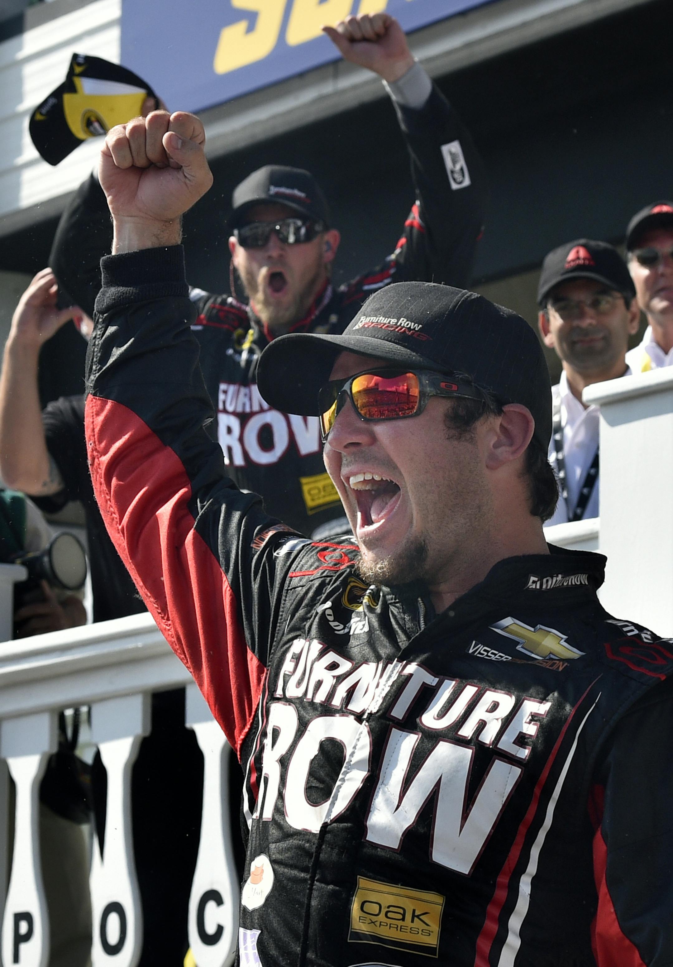 Martin Truex Jr. (78) celebrates in Victory Lane at Pocono Raceway after winning a NASCAR Sprint Cup Series auto race at Pocono Raceway in Long Pond, Pa., Sunday, June 7, 2015. (AP Photo/Derik Hamilton)