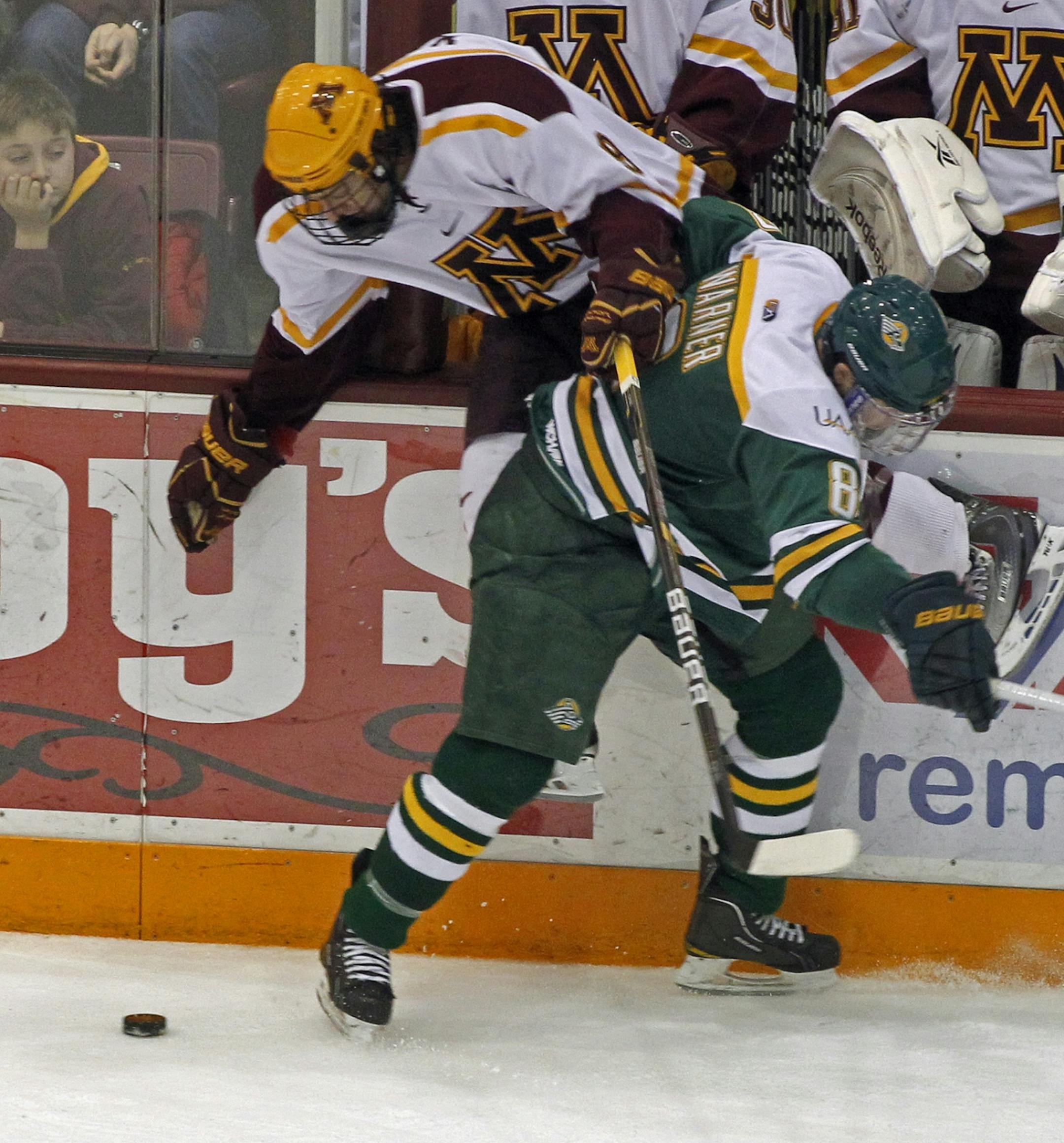 Alaska played a physical game Saturday night. Here Alaska's Scott Warner (8) checked Gophers Taylor Matson into the boards in 2nd period action.
