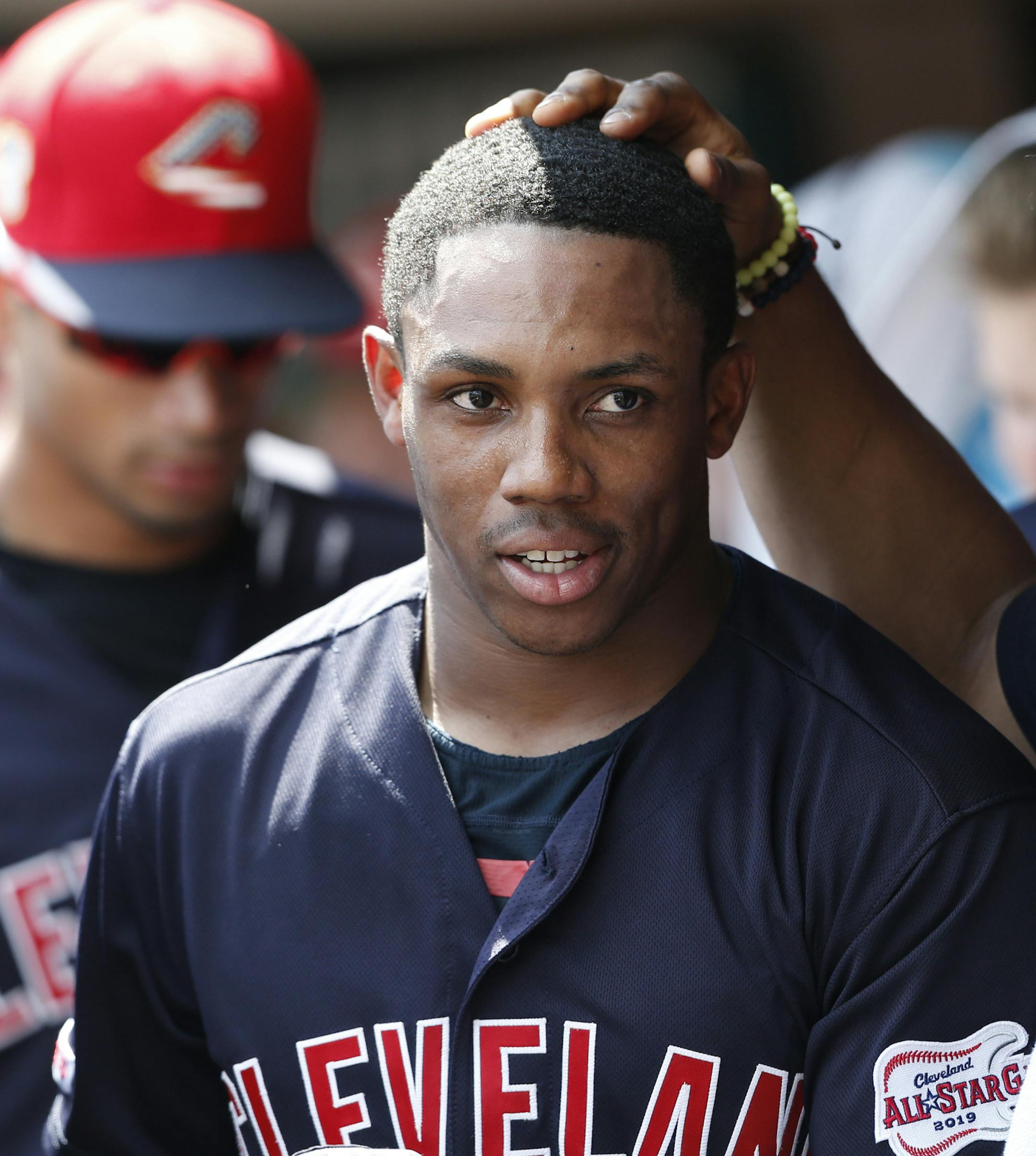 Cleveland Indians' Greg Allen, front left, is congratulated by Francisco Lindor, right, on his two-run home run off Cincinnati Reds relief pitcher Jimmy Herget during the eighth inning of a baseball game, Sunday, July 7, 2019, in Cincinnati. (AP Photo/Gary Landers)