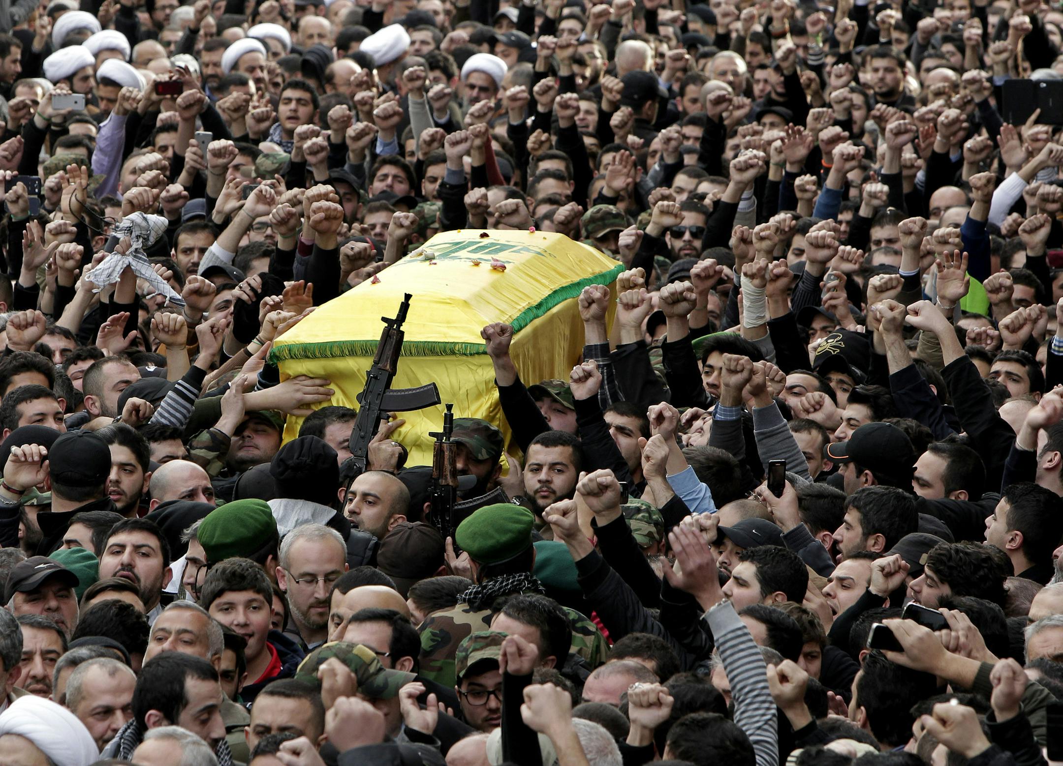 Hezbollah fighters carry the coffin of Jihad Mughniyeh, the son of Imad Mughniyeh, a top Hezbollah operative assassinated in 2008 in Damascus and one of the six Hezbollah fighters killed in what the group said was an Israeli airstrike Sunday in the Golan, during his funeral procession, in southern Beirut, Lebanon, Monday, Jan. 19, 2015. Jihad Mughniyeh is the Hezbollah's most prominent figure to die so far in Syria since the Shiite militant group joined the conflict next door in 2012, fighting o