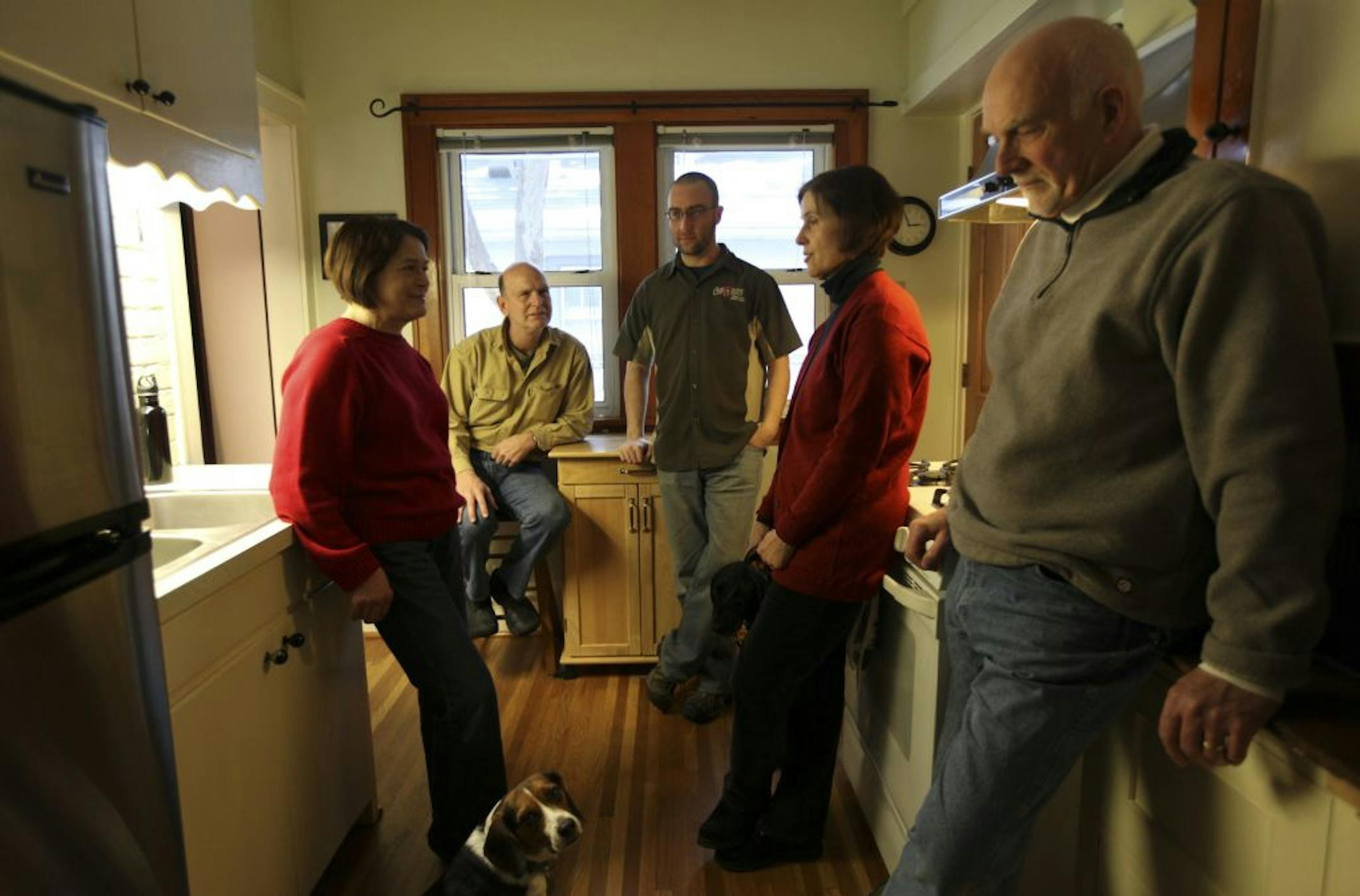 From left, Wendy Anderson, Earl Hartranft, Mark Meyer have stayed with Bobbie Anderson and her husband Gerald Tomberlin in the last two years in the their home in Minneapolis Min., Friday, January 27, 2012. Ten people two dogs and a cat have lived off and on in this 800 square foot home due financial hard times or health issues. Now Anderson and Tomberlin are selling the house because they can't keep up with the payments.