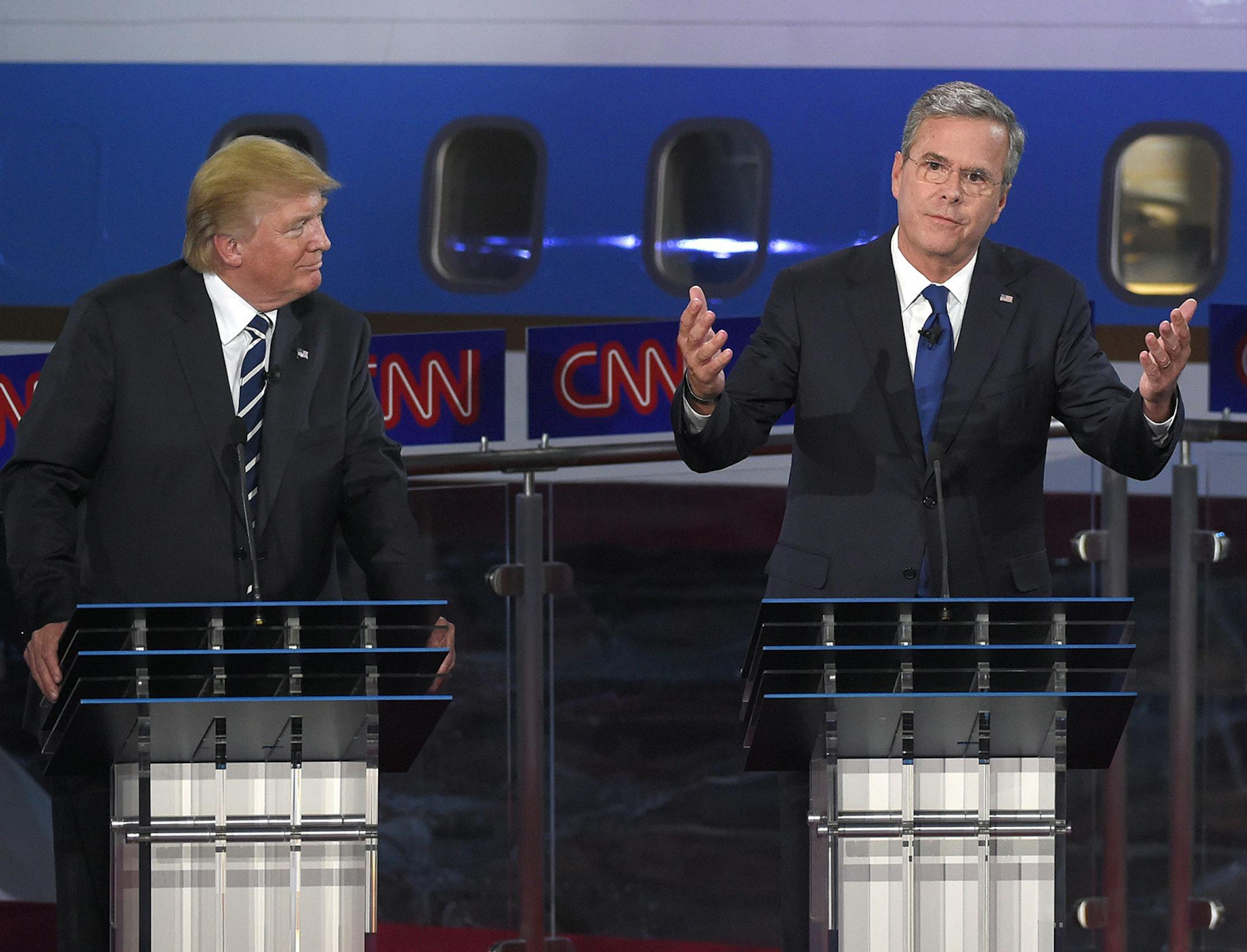 Republican presidential candidate, former Florida Gov. Jeb Bush, center, gestures as Donald Trump, left, and Scott Walker look on during the CNN Republican presidential debate at the Ronald Reagan Presidential Library and Museum on Wednesday, Sept. 16, 2015, in Simi Valley, Calif. (AP Photo/Mark J. Terrill) ORG XMIT: MIN2015091711492667