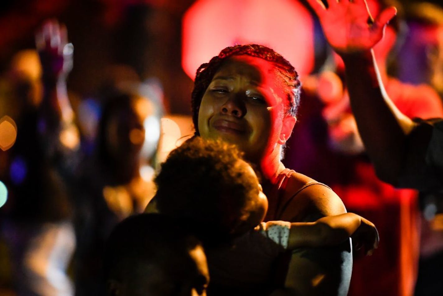 A woman was overcome with emotion during a prayer held for the man killed by Minneapolis Police hours earlier in North Minneapolis. She was part of an inner prayer circle for family.