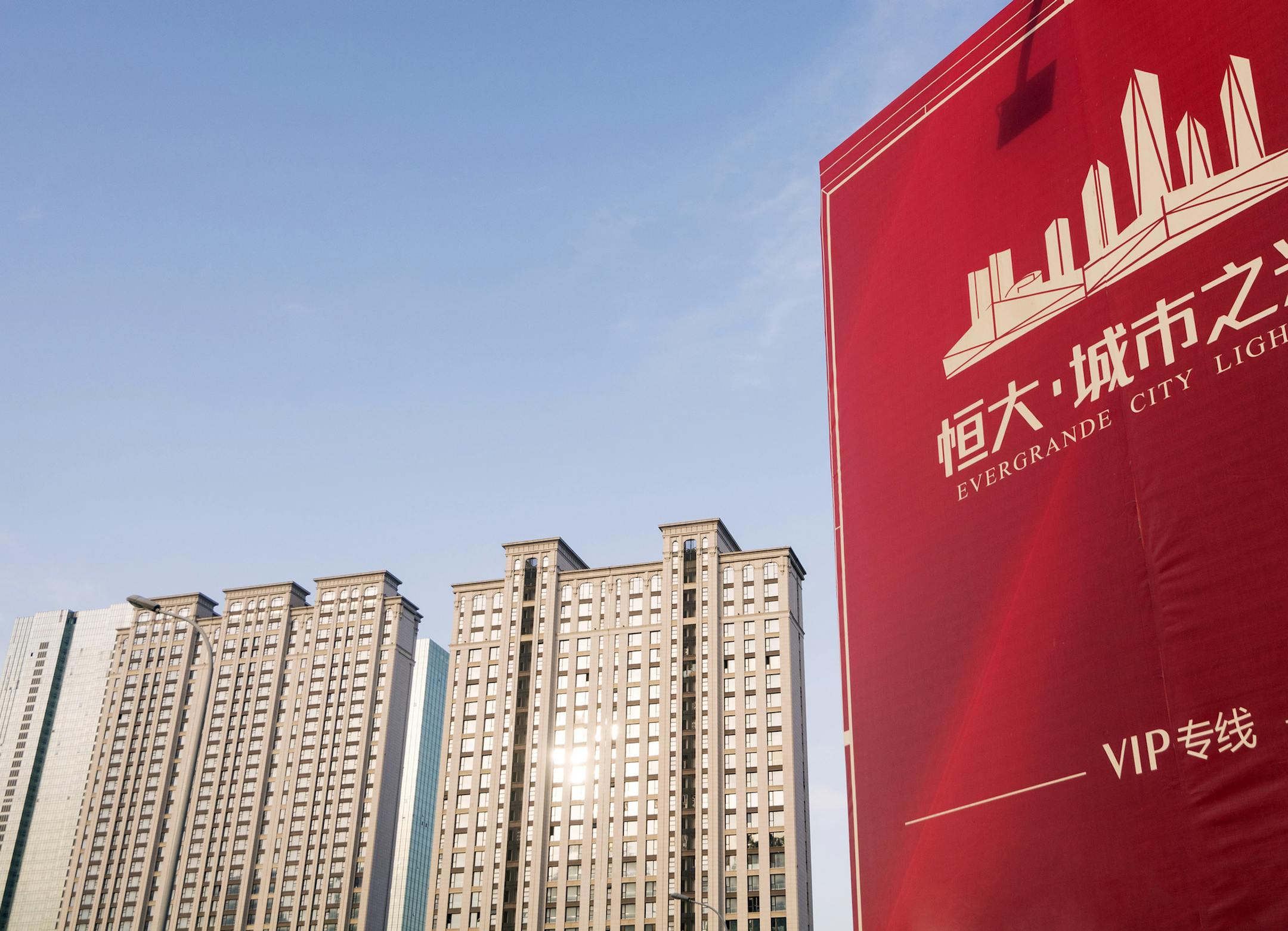 --FILE--View of a signboard of Evergrande City Lights in Dalian city, northeast China's Liaoning province, 18 January 2018. China Evergrande Group, China's third-largest developer by sales, issued a positive profit alert on Thursday (8 March 2018), saying that it expected a substantial increase in 2017 net profit, in the order of "four to five times that of last year", thanks to reductions in interest expenses and other factors. The profit alert was made in a filing to the Hong Kong stock exchan