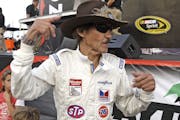 Former NASCAR driver Richard Petty wears a throwback driving suit to celebrate the 25th Anniversary of his 200th win prior to the Coke Zero 400 auto r