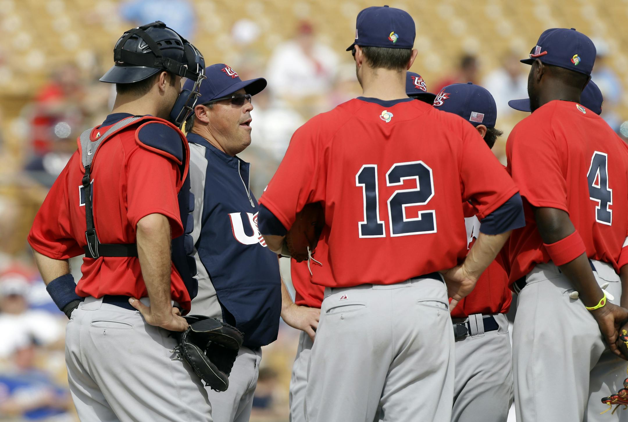 United States pitching coach Greg Maddux, second from left, talks to his infield during an exhibition baseball game against the Chicago White Sox Tuesday, March 5, 2013, in Glendale, Ariz. (AP Photo/Mark Duncan) ORG XMIT: NYOTK