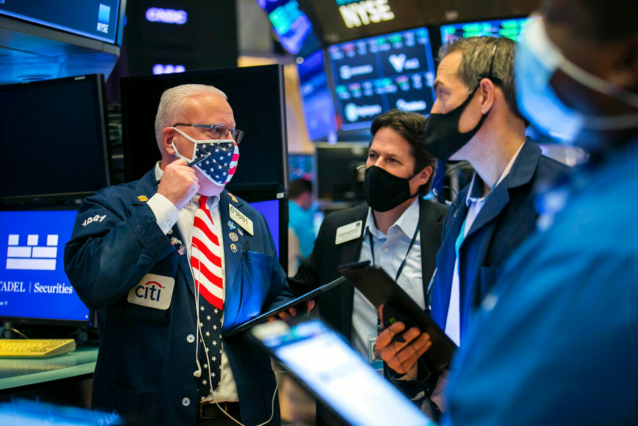 Thomas Ferrigno, left, works with fellow traders on the floor, Nov. 11, 2020.