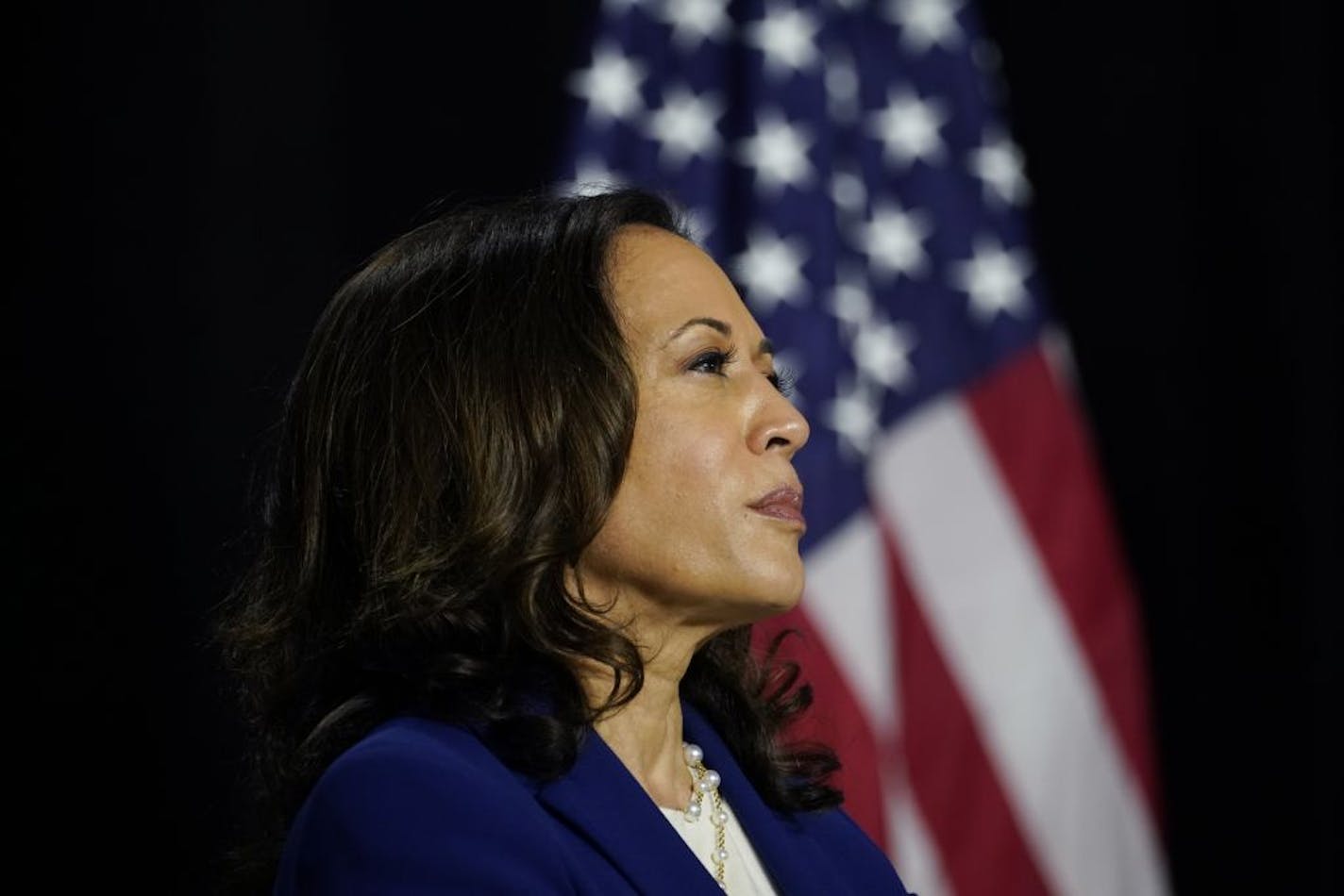 Democratic presidential candidate former Vice President Joe Biden's running mate Sen. Kamala Harris, D-Calif., looks to him during a campaign event at Alexis Dupont High School in Wilmington, Del., Wednesday, Aug. 12, 2020.