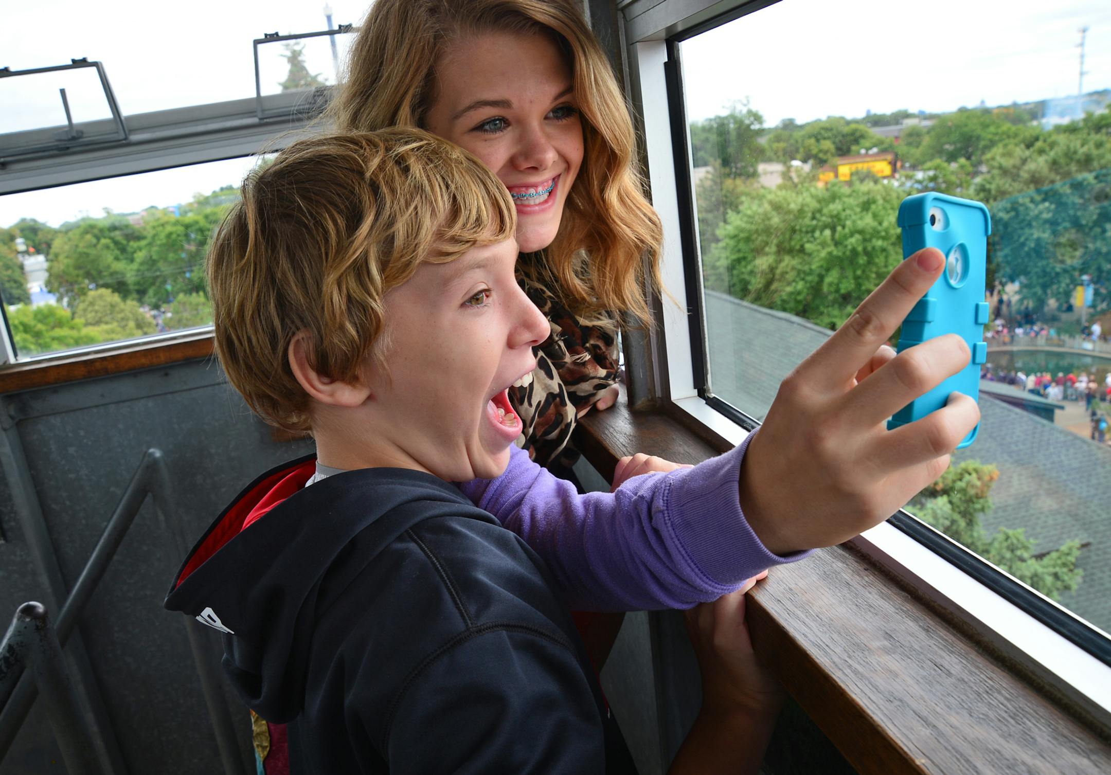 The DNR State Fair fire tower is a free and popular attraction that reaches 65 feet in the air and is a great vantage point to view the Minnesota State Fair. Emilee Falch 14 years old of Northfield, took a selfie with her 11 year old brother, Isaak at the top of the fire tower. ] Richard.Sennott@startribune.com Richard Sennott/Star Tribune Falcon Heights Minnesota Monday 9/2/13) ** (cq)
