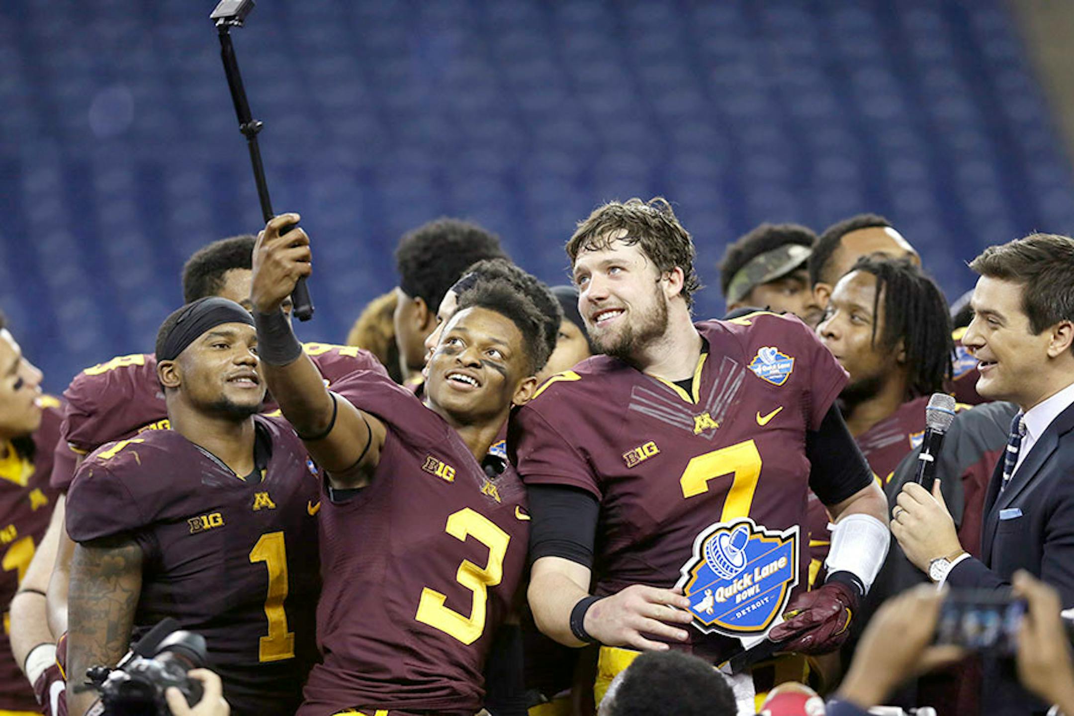 Minnesota defensive back KiAnte Hardin (3) takes a photo with quarterback Mitch Leidner (7) after their Quick Lane Bowl NCAA college football game against Central Michigan, Monday, Dec. 28, 2015, in Detroit. Minnesota defeated Central Michigan 21-14.