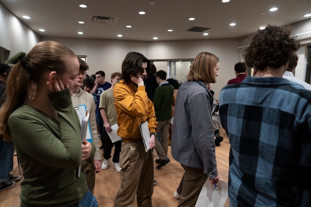 Students walk around a recording studio at the University of St. Thomas, listening to trumpet music and noting how the sound changes in different pockets of the room.
