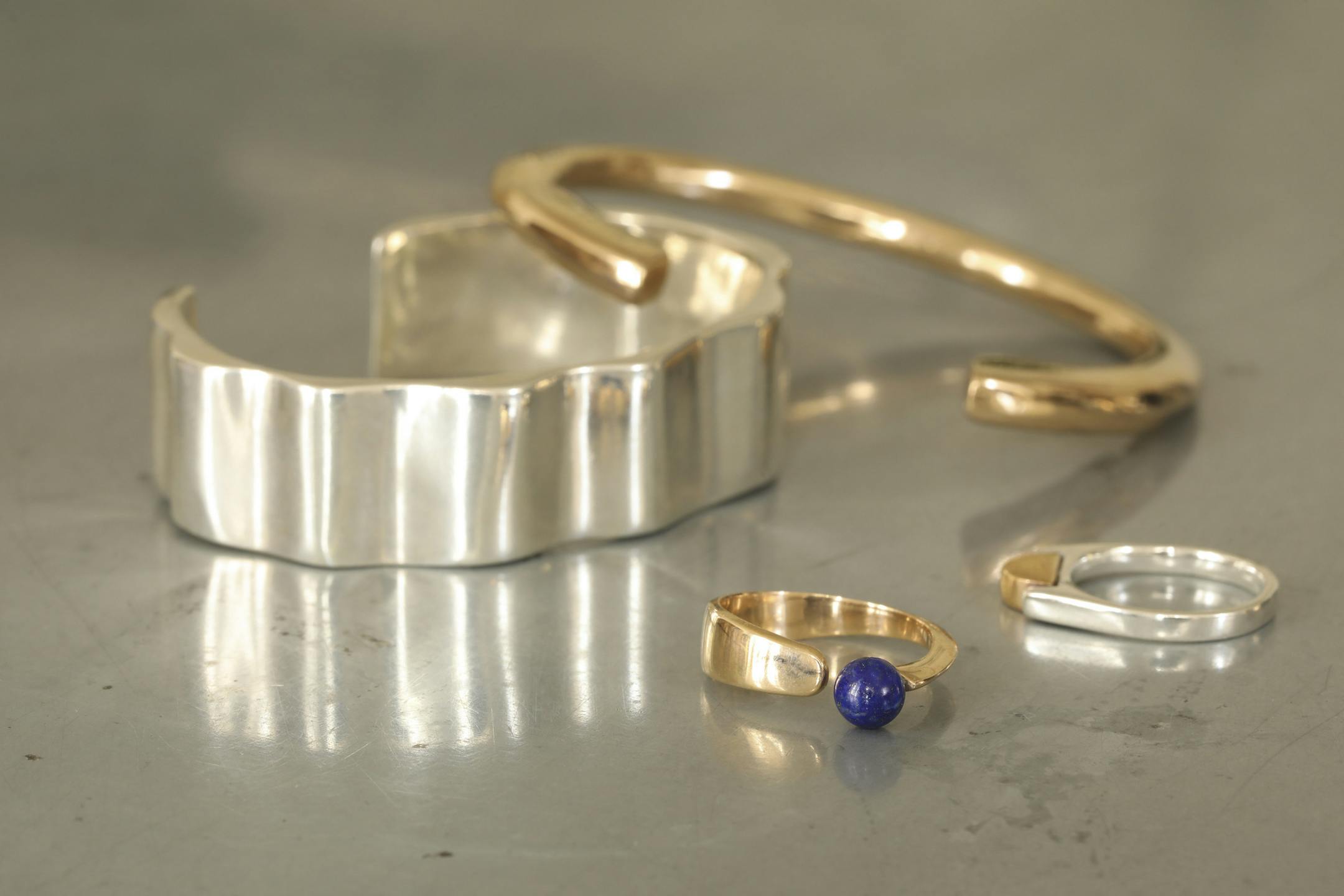 A pair of bracelets and a pair of rings by Lauren Neal.