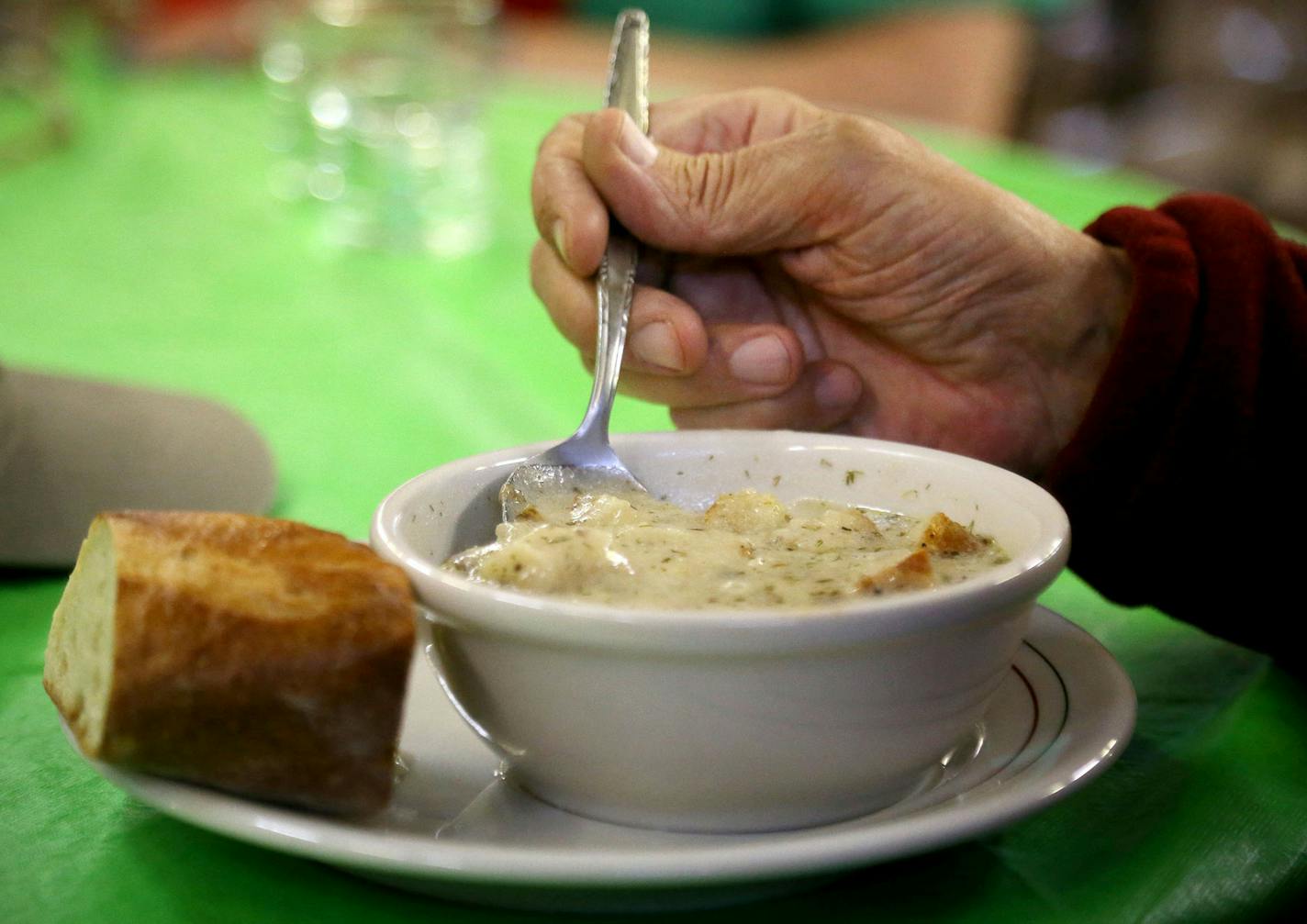 Diner Rick Mittelstedt digs into his bowl of creamy potato dill soup at the Soup for You! Cafe Tuesday, March 31, 2015, at Bethany Lutheran Church in Minneapolis, MN.](DAVID JOLES/STARTRIBINE)djoles@startribune.com A Lutheran pastor (Mike Matson) and a refugee from Tunisia (Judah Nataf) have joined forces to redefine the soup kitchen. The gourmet soup they prepare is mostly organic. The clientele is a mixture of foodies who come in and pay for the meal and (using that money) those who eat for fr