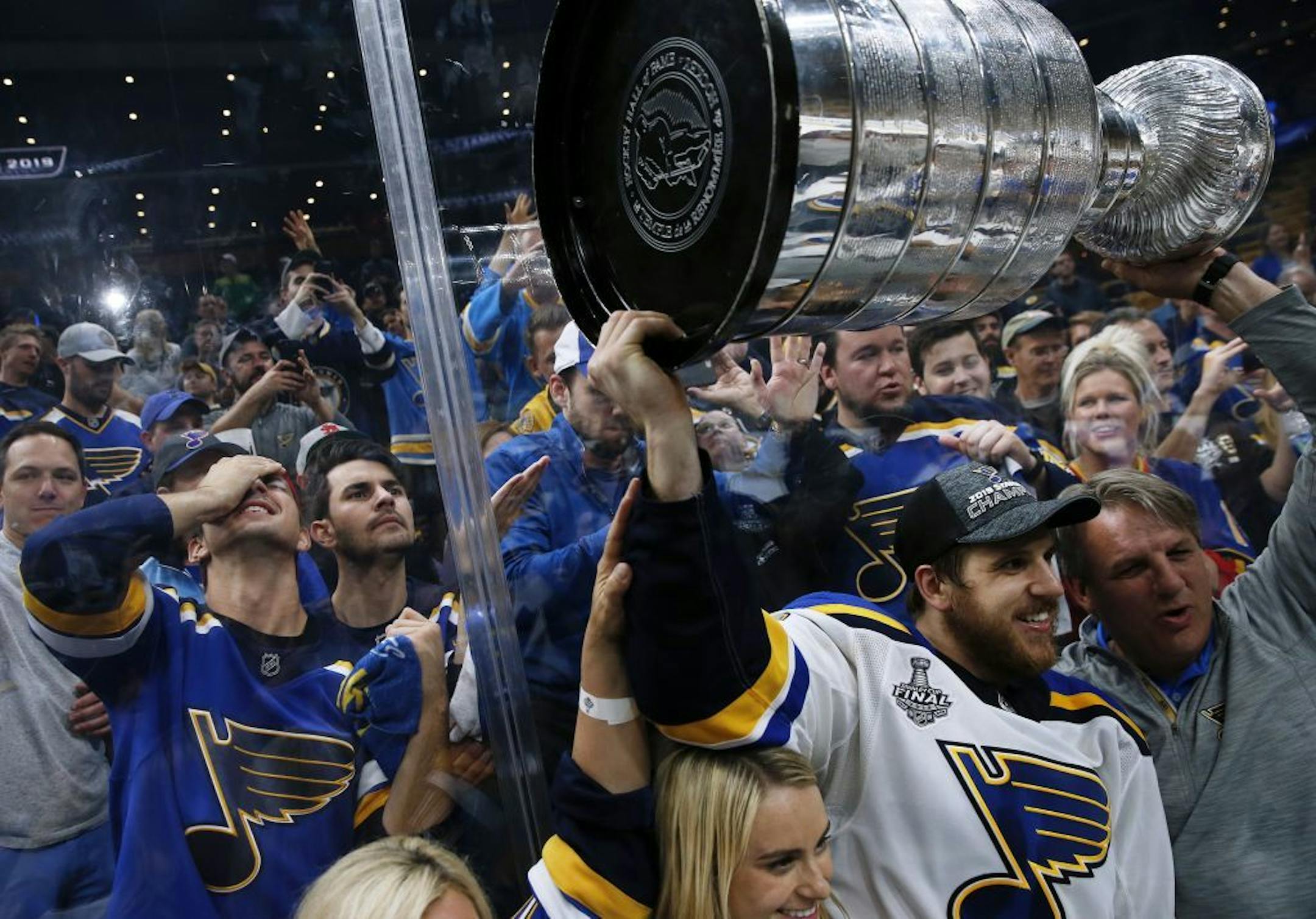 Brayden Schenn carries the Stanley Cup as Blues fans who made the trip to Boston celebrated.